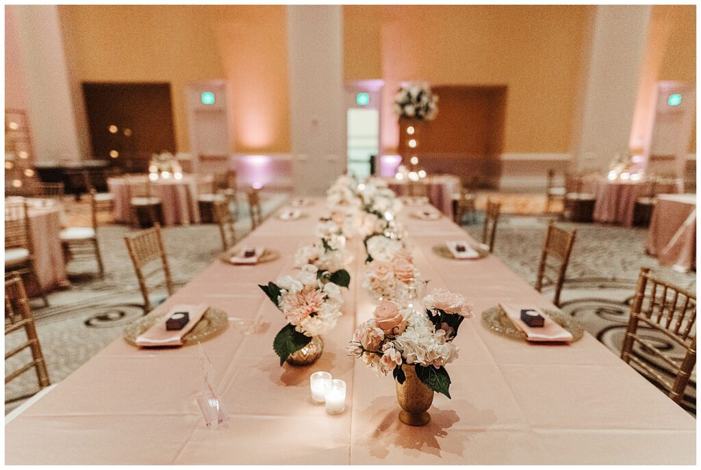 Pink wedding table setting with flower bouquets