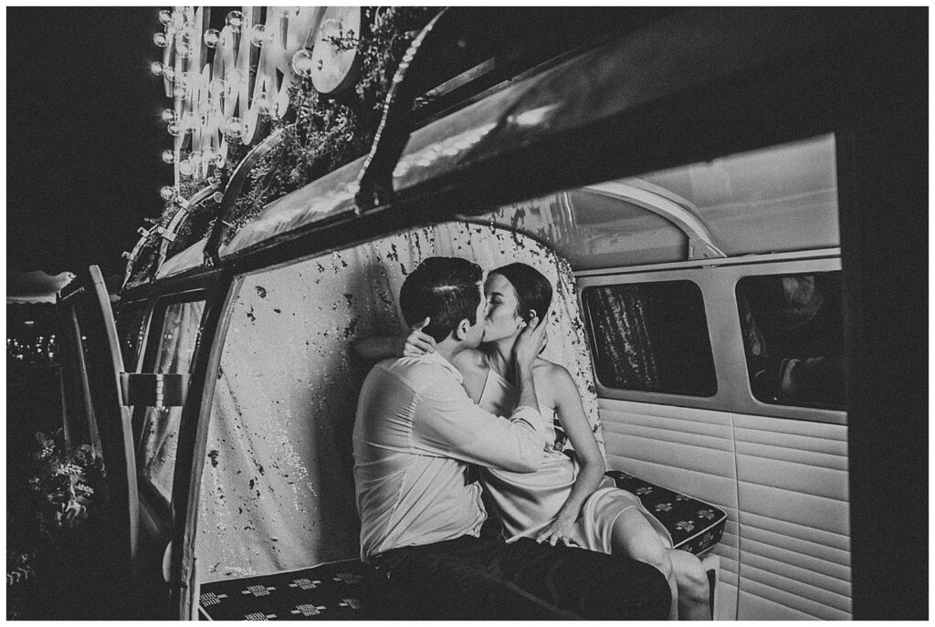 black and white photo of bride and groom kissing in photo booth