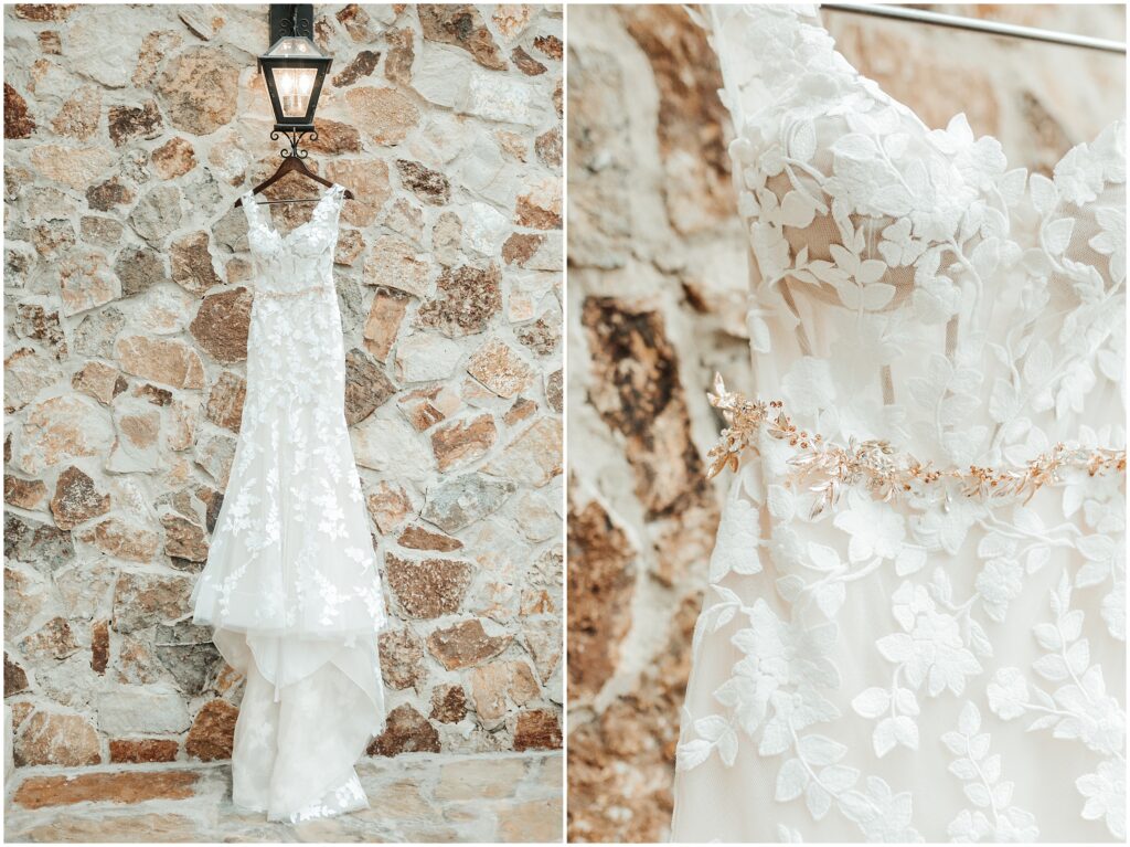 sheer floral lace wedding gown with rose gold waistline details hangs on a rustic lamp 