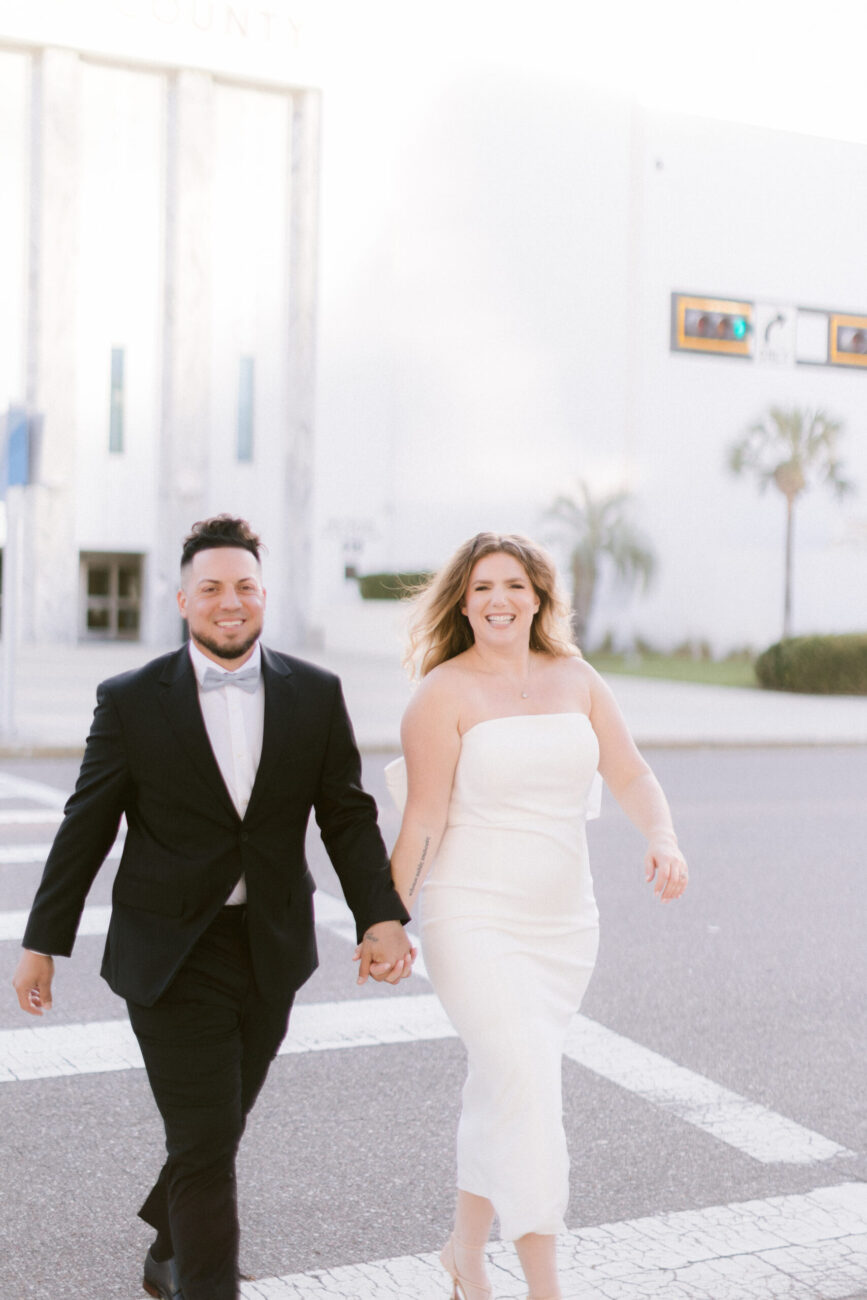 Bride and groom walking hand in hand after their Tampa courthouse elopement