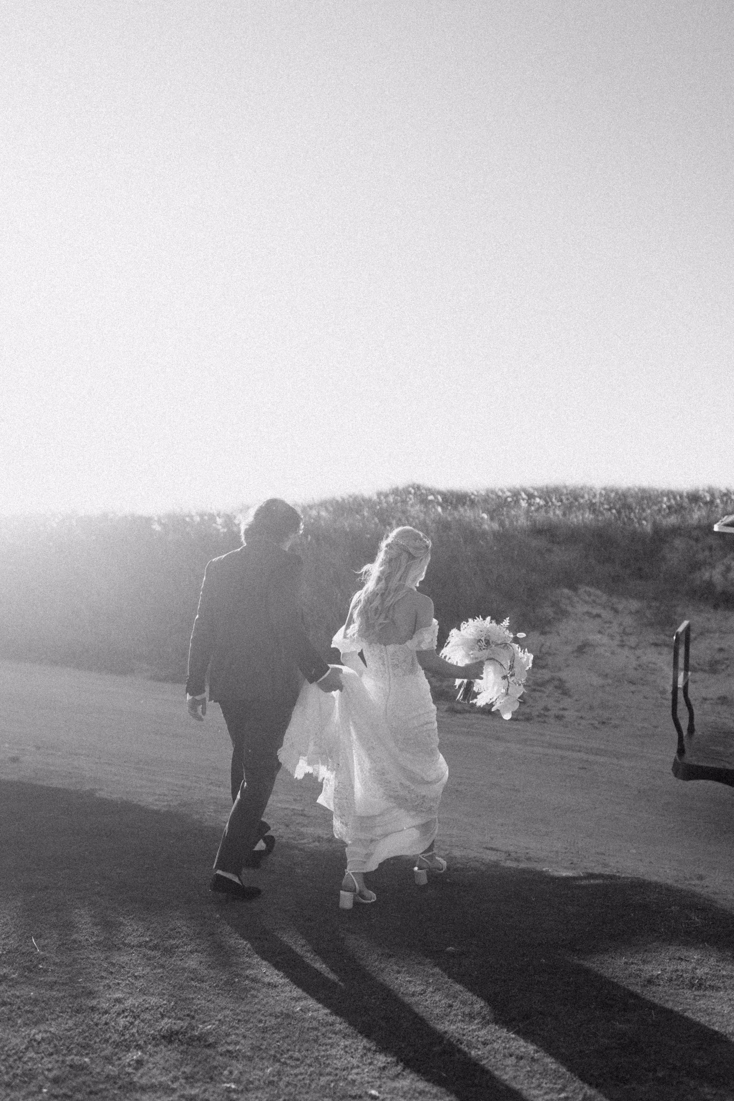Bride and groom running together at sunset on beach during Tampa Bay wedding photographed by Ashley Izquierdo Photography