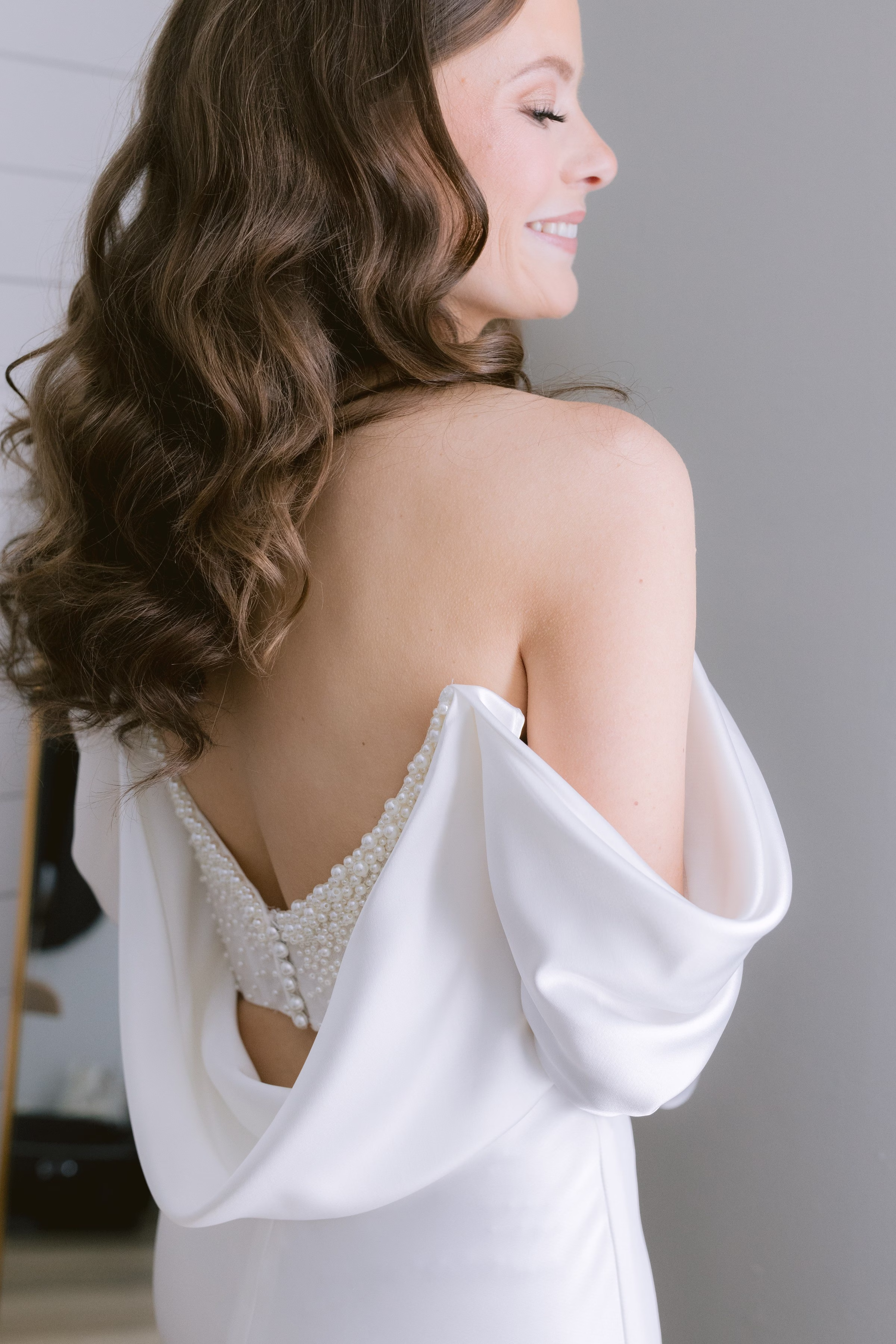 elegant bride portrait white dress curly hair ashley izquierdo photography tampa - Experience Elegant bridal portrait showcasing off-shoulder wedding dress with pearl details and flowing sleeves by Tampa Bay wedding photographer Ashley Izquierdo Photography