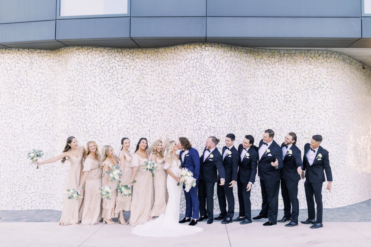 modern tampa wedding party portrait bridesmaids groomsmen ashley izquierdo photography - Experience Wedding party portrait with bridesmaids in blush dresses and groomsmen in navy suits against modern mosaic wall at Tampa Bay wedding venue