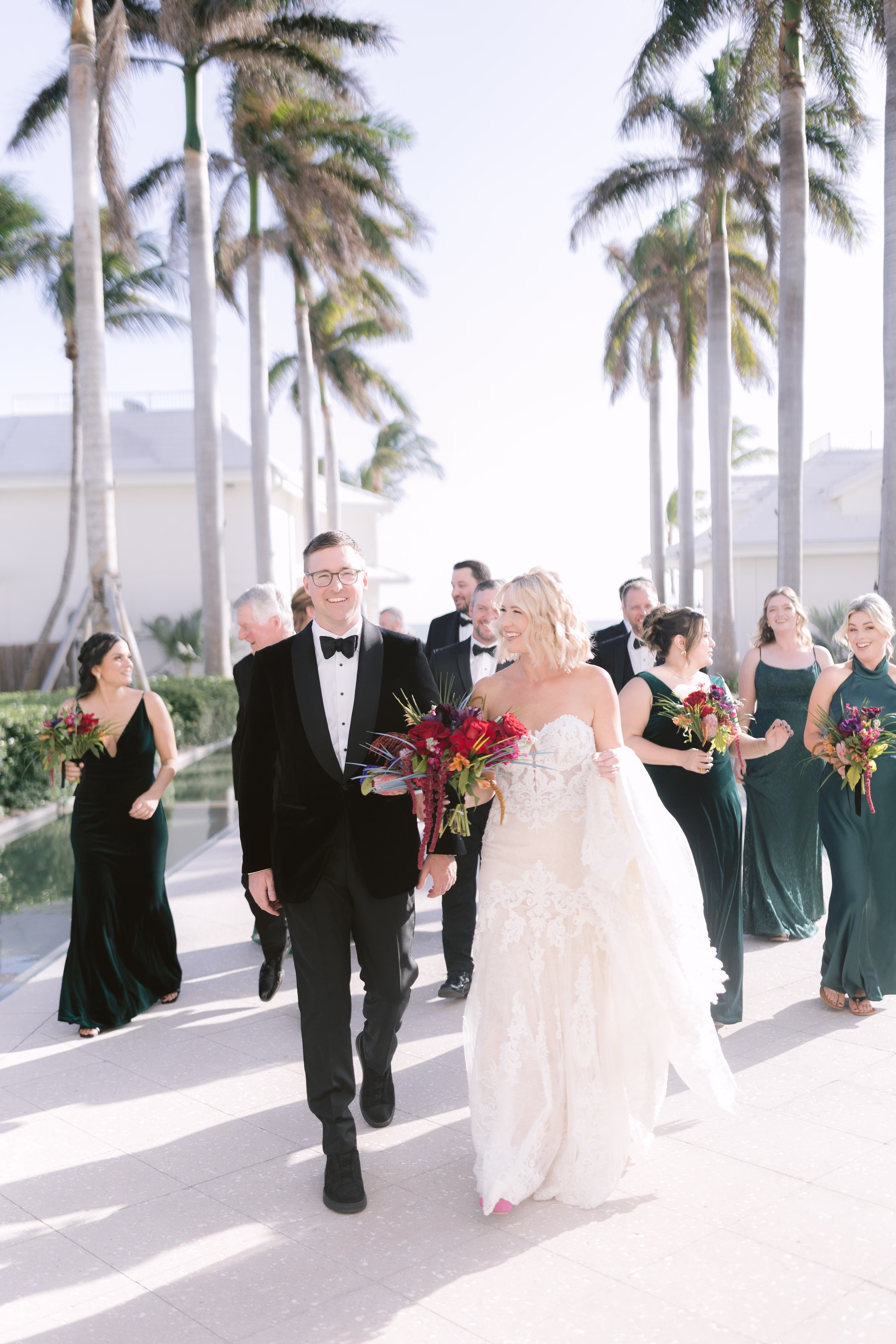 tropical palm tree wedding party processional tampa bay wedding photographer ashley izquierdo - Home Wedding party walking together under palm trees at tropical Tampa Bay wedding venue captured by Ashley Izquierdo Photography