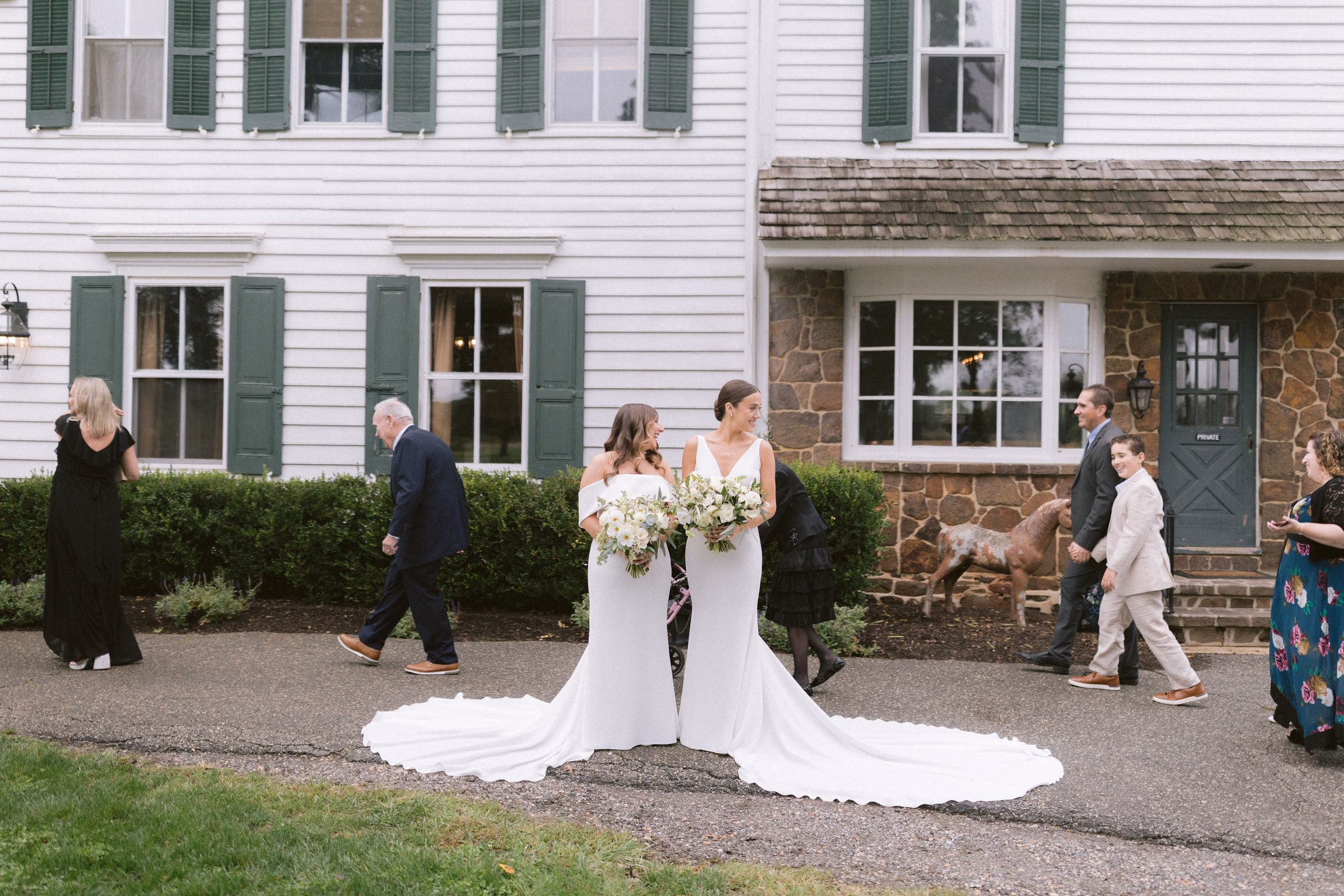 two brides white wedding dresses historic venue tampa wedding photographer ashley izquierdo - Home Two brides in white wedding gowns walking together during their wedding ceremony processional at a historic colonial style venue