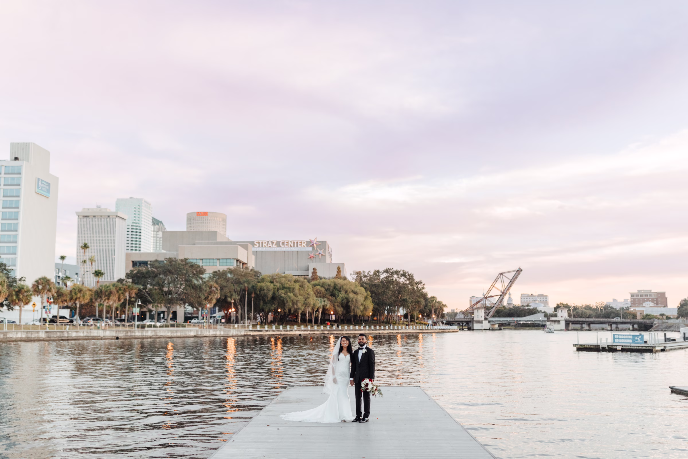 downtown tampa wedding portrait straz center waterfront - About Ashley Izquierdo Bride and groom wedding portrait on waterfront dock with downtown Tampa skyline and Straz Center in background by Ashley Izquierdo Photography