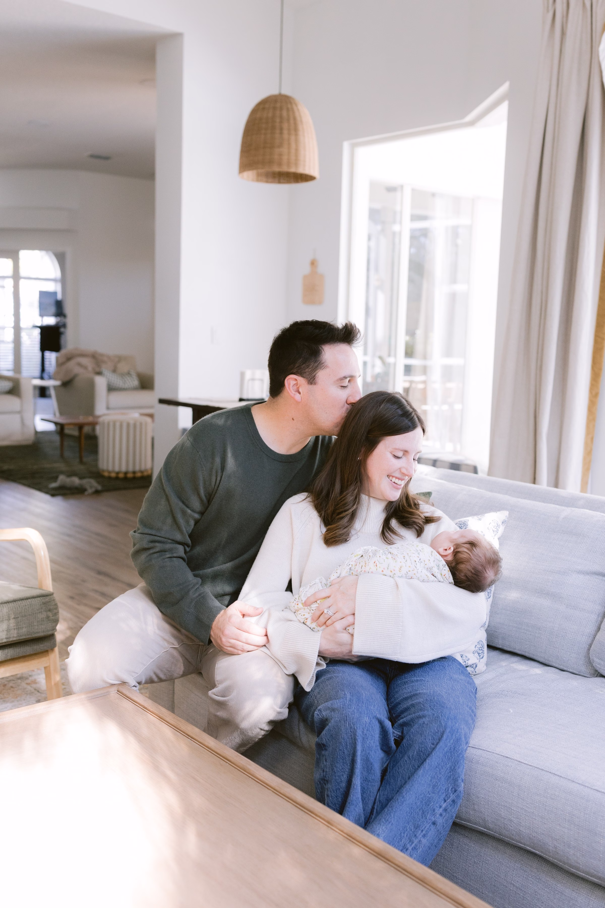 Tampa Bay maternity and family photography session by Ashley Izquierdo Photography featuring parents with newborn baby in modern home