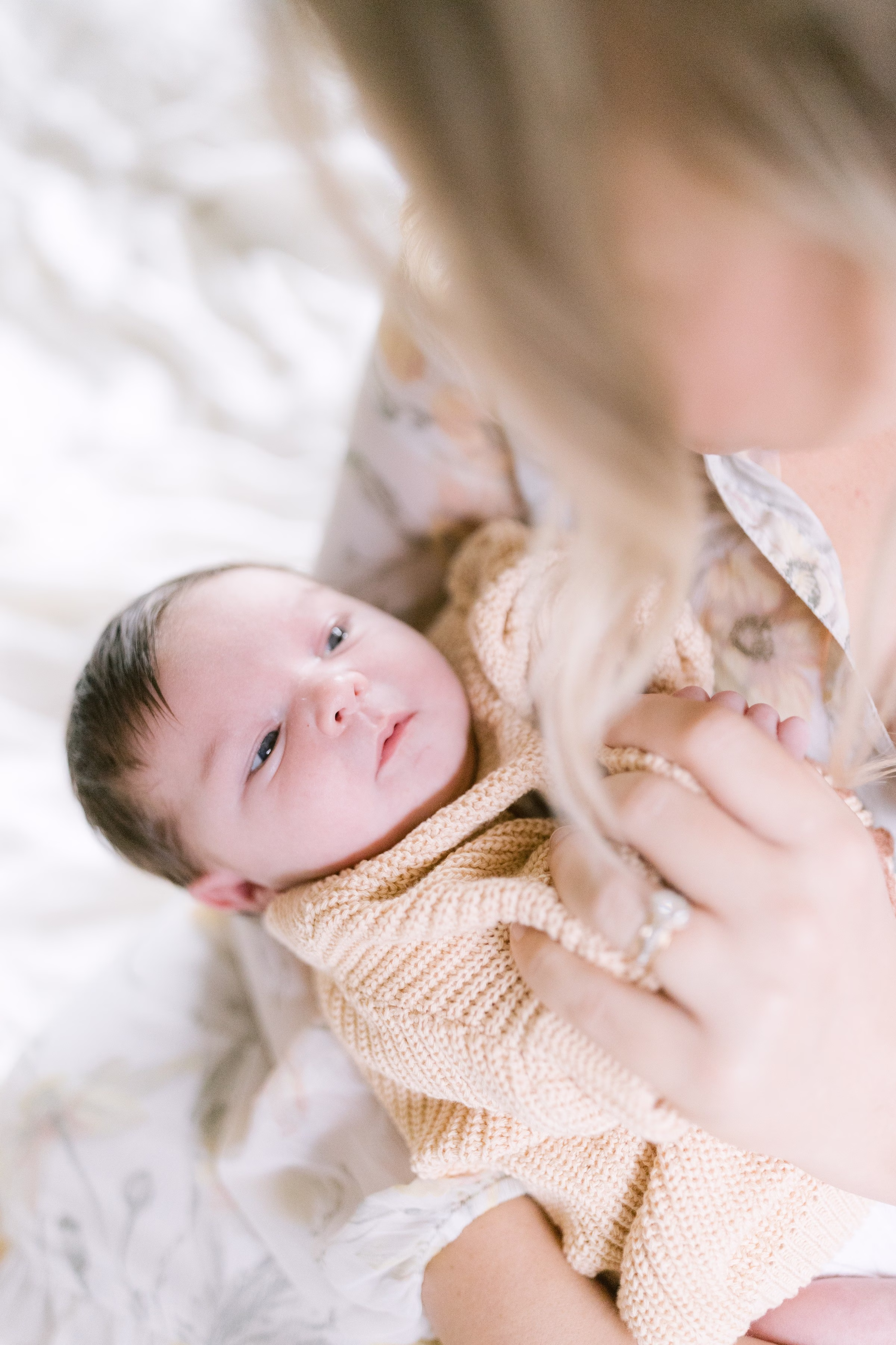 Newborn baby portrait in knit outfit captured by Tampa Bay photographer Ashley Izquierdo Photography