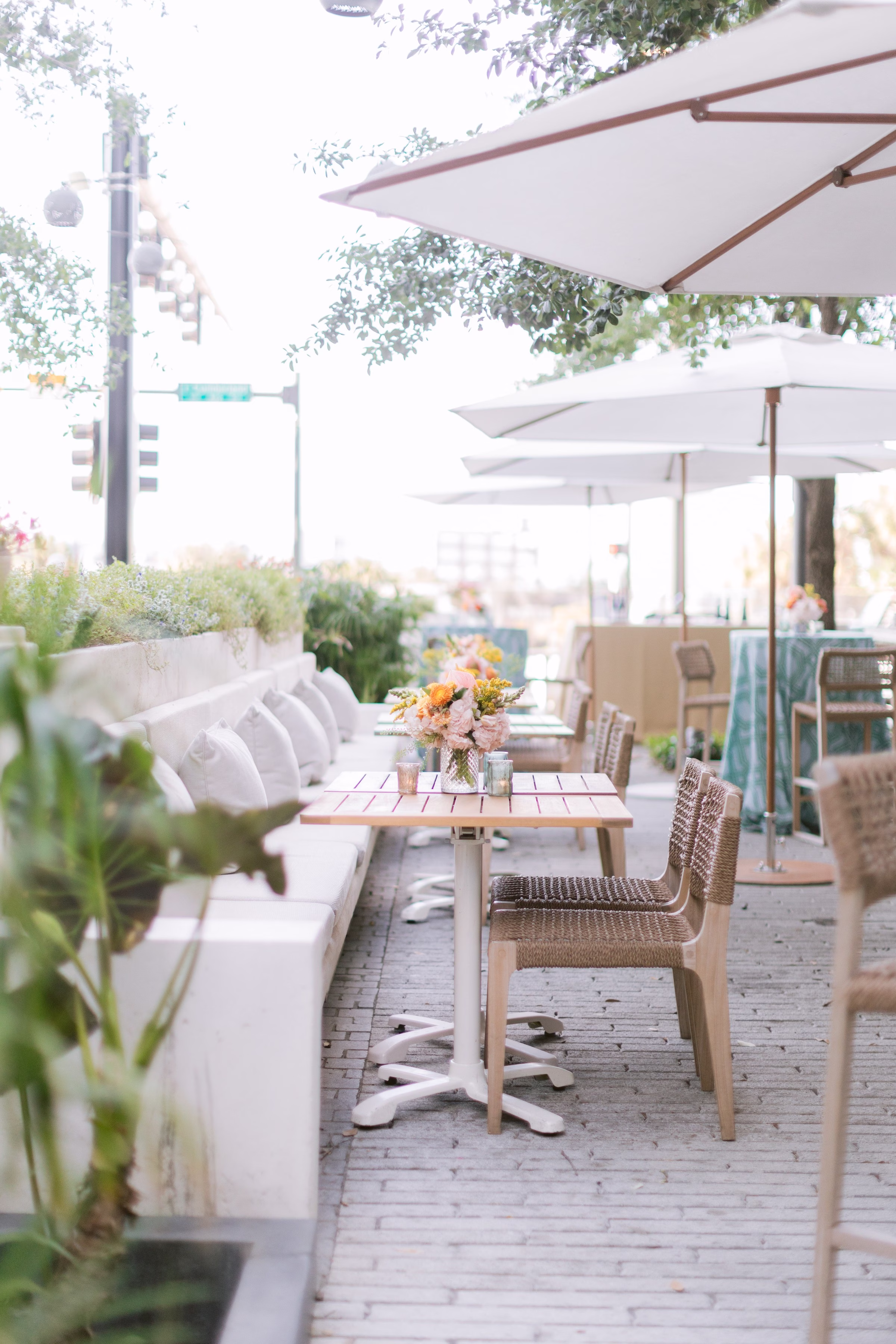 Elegant outdoor restaurant terrace with wicker chairs and umbrellas captured by Tampa Bay photographer Ashley Izquierdo Photography