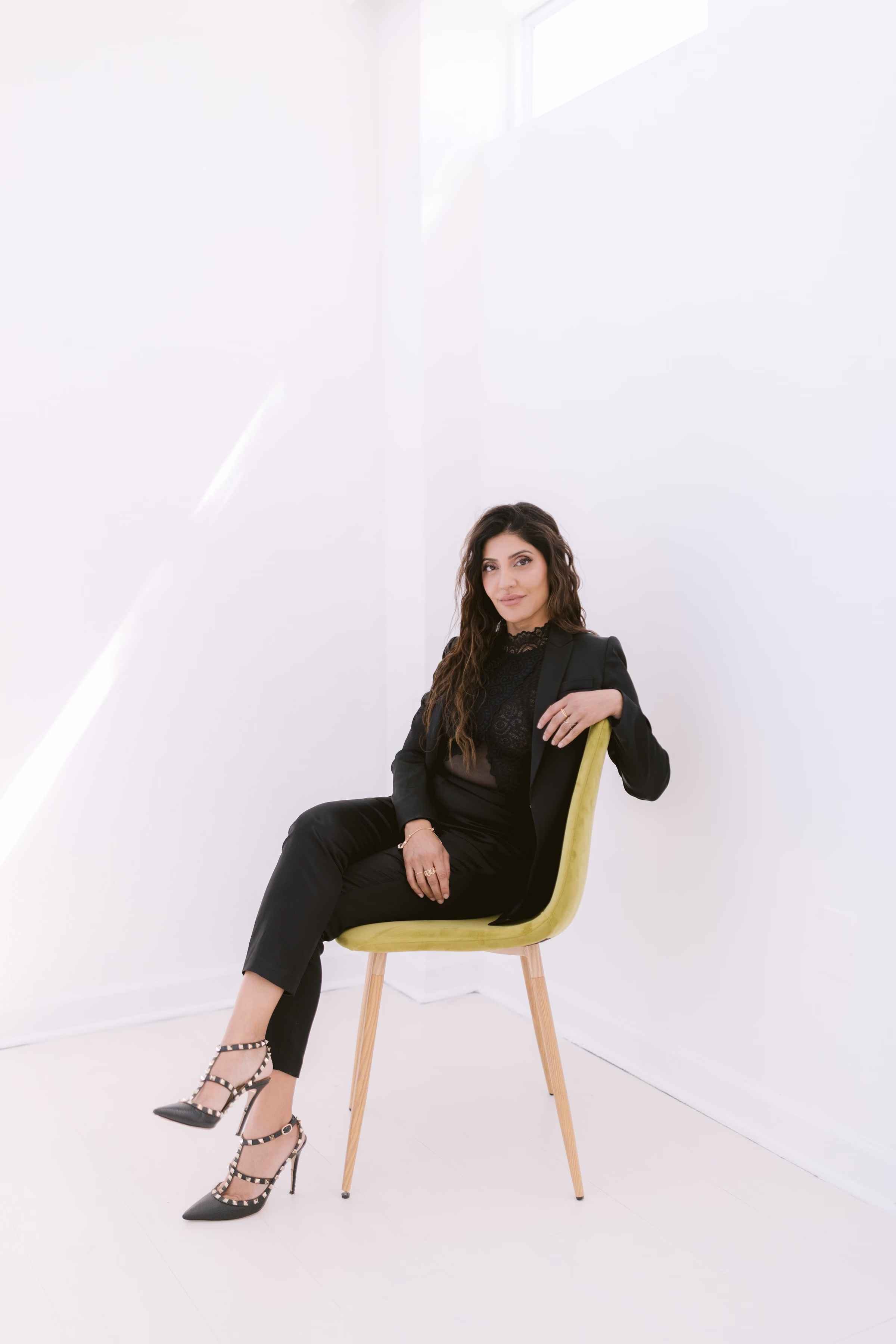 professional headshot branding photography yellow chair black outfit - Headshots & Branding Professional branding headshot of woman in black outfit sitting on modern yellow chair in Tampa Bay studio