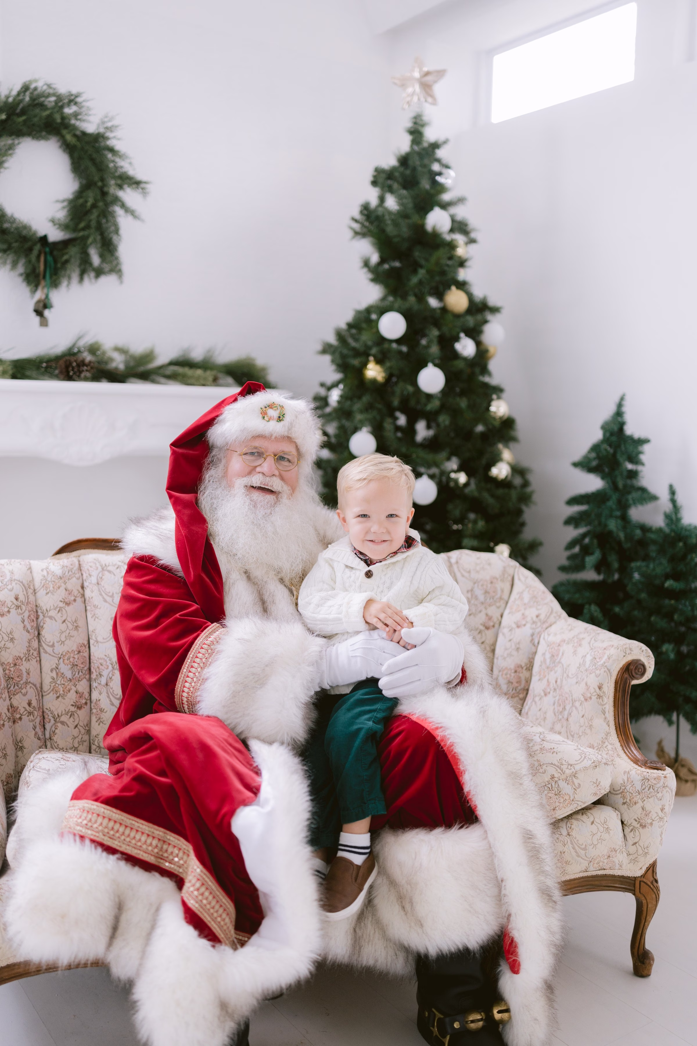 Child sitting with Santa Claus during Christmas mini session photographed by Tampa Bay photographer Ashley Izquierdo Photography