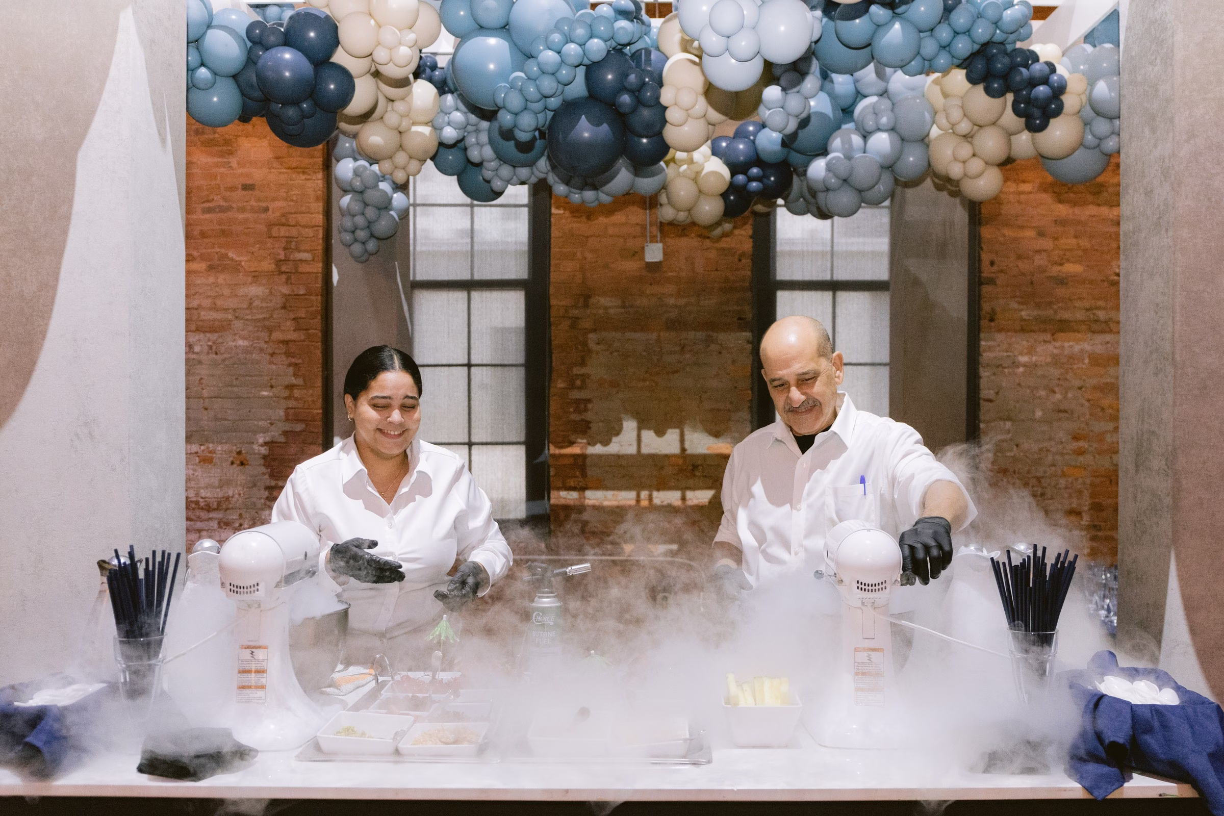 Corporate event photographers capture scientists performing liquid nitrogen demonstration with balloon installation at Tampa Bay venue
