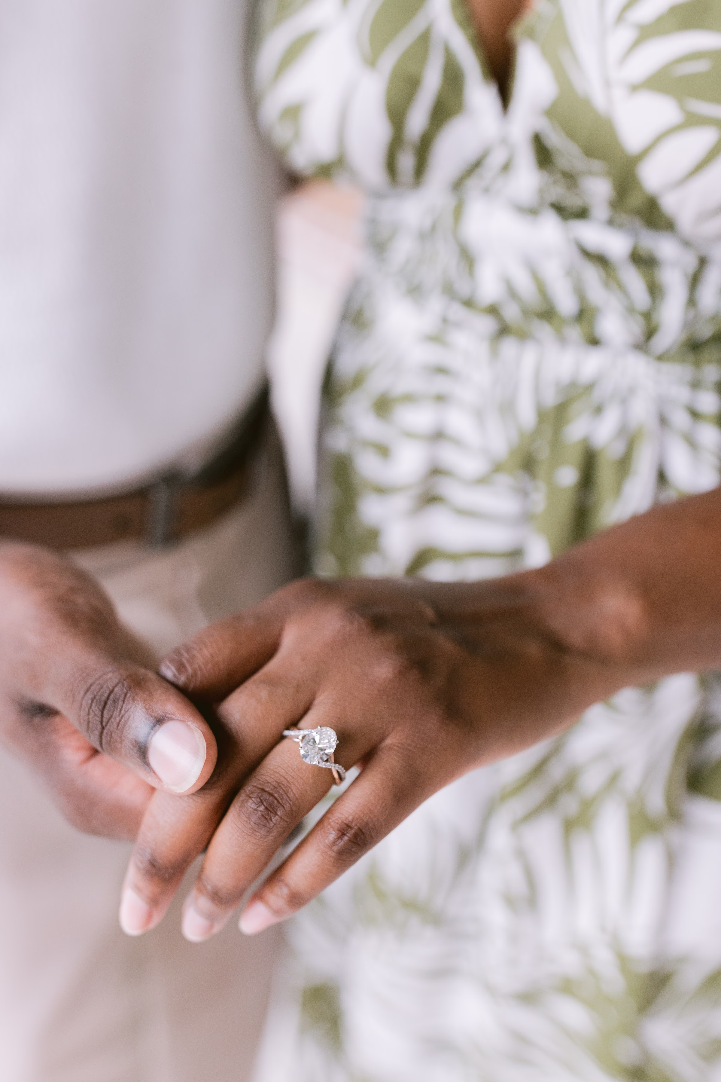 Close up of diamond engagement ring on bride's hand during Tampa Bay engagement session by Ashley Izquierdo Photography