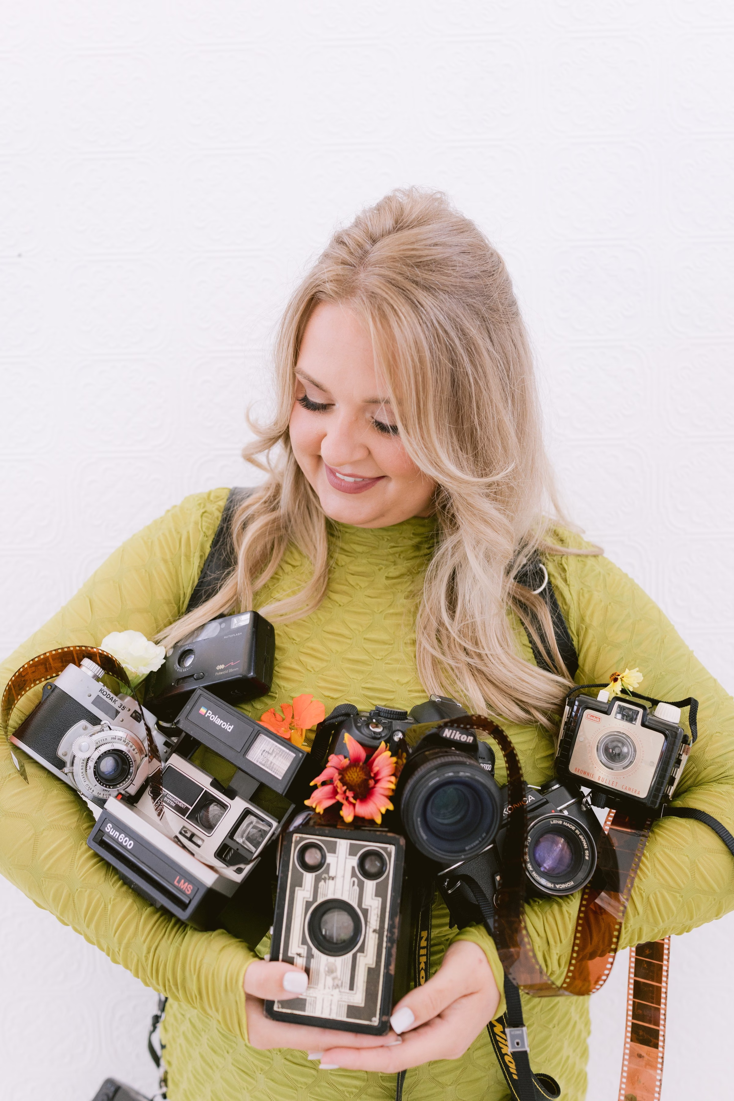 Tampa Bay photographer branding session featuring vintage cameras and film rolls in lime green outfit