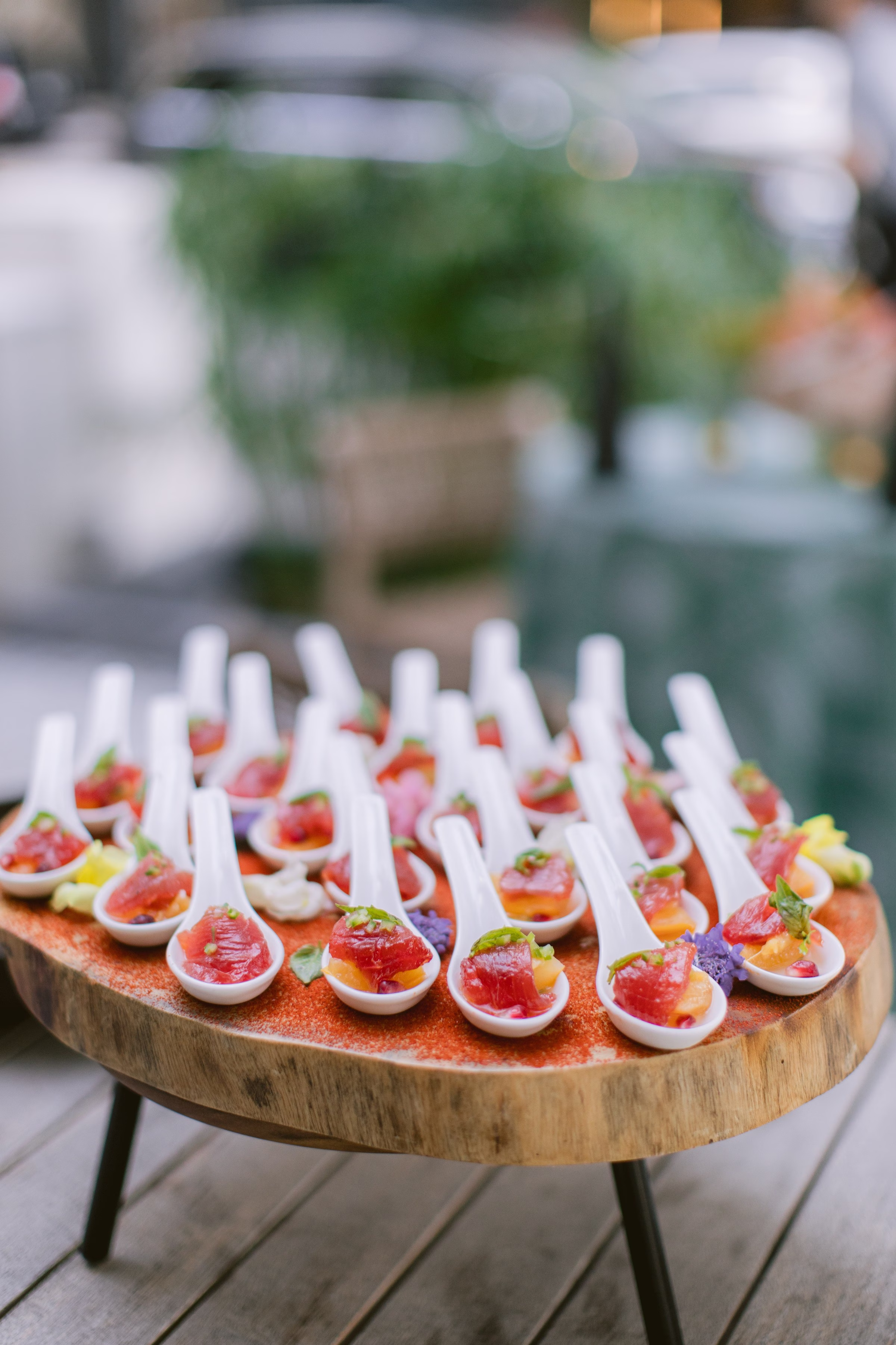 Elegant wedding appetizer spoons with fresh garnishes displayed on wooden serving board at Tampa Bay wedding by Ashley Izquierdo Photography