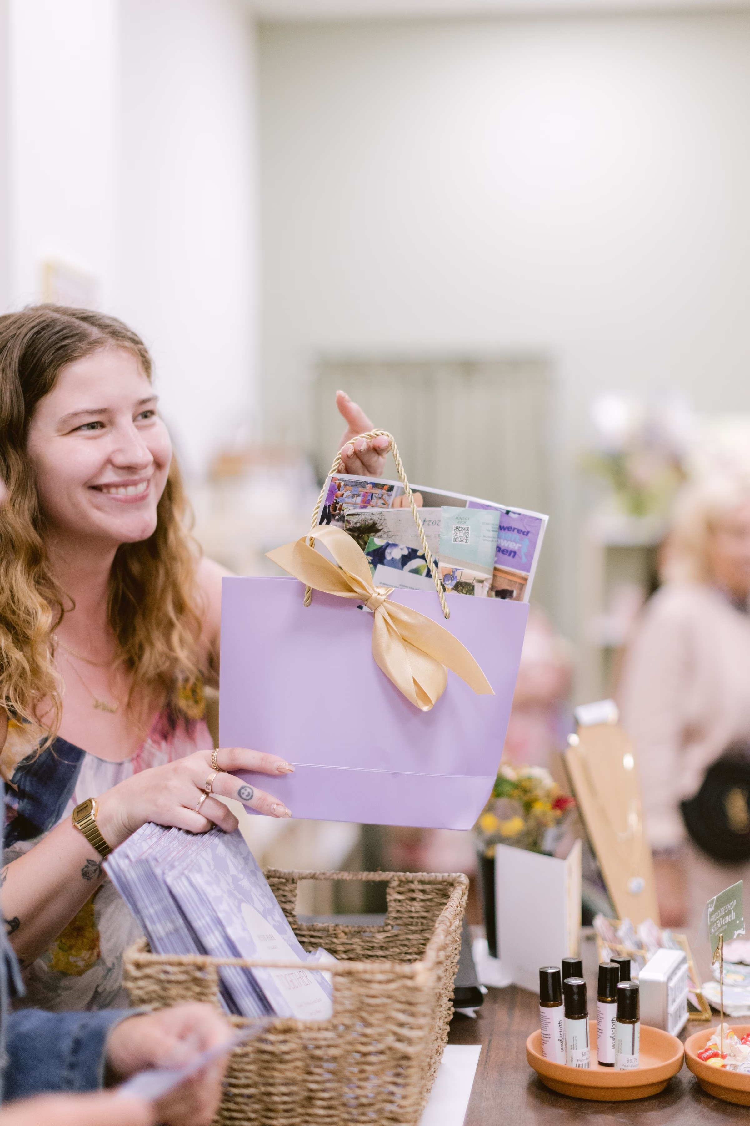 Bride receiving purple gift bag with gold ribbon during Tampa Bay wedding event photographed by Ashley Izquierdo Photography