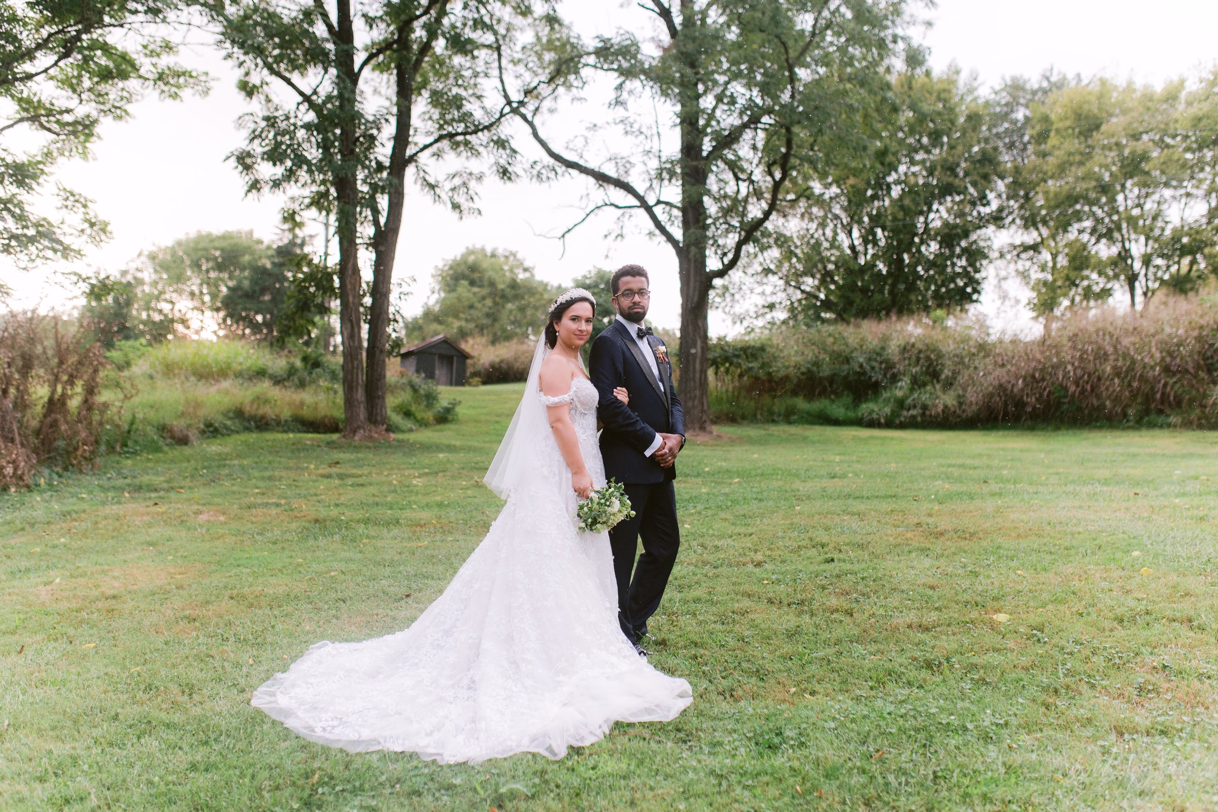 tampa bay wedding photography bride groom outdoor portrait - Experience Elegant bride and groom pose together on green lawn under trees during their Tampa Bay wedding photographed by Ashley Izquierdo Photography