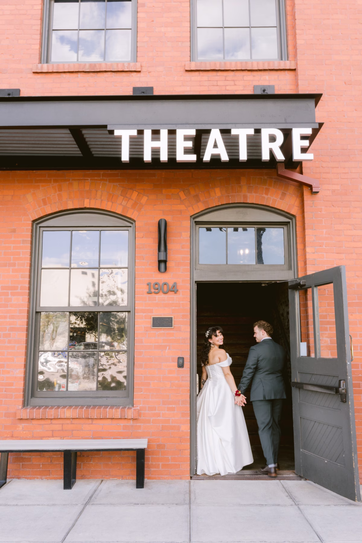 Bride and groom enter historic theatre at Armature Works wedding venue in Tampa photographed by Ashley Izquierdo Photography