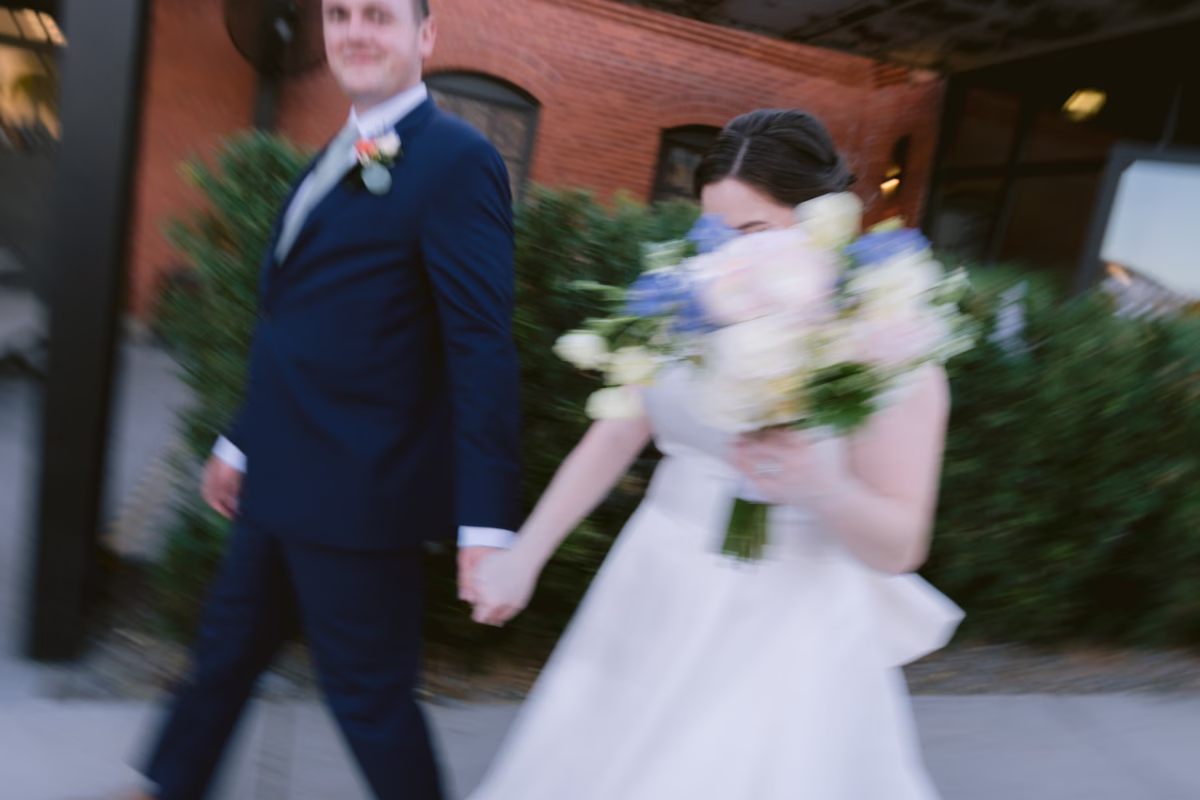 Bride and groom captured in motion blur during wedding exit at Armature Works Tampa by Ashley Izquierdo Photography