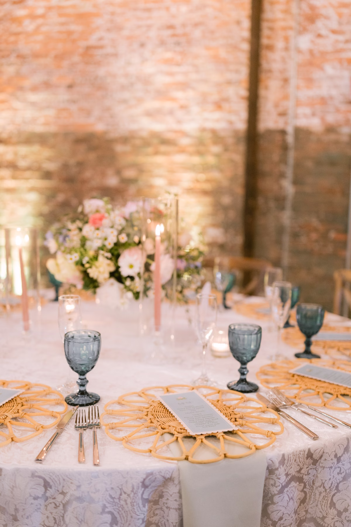 Elegant wedding reception tablescape with blue glassware and floral centerpiece by I Dew Events at Armature Works Tampa