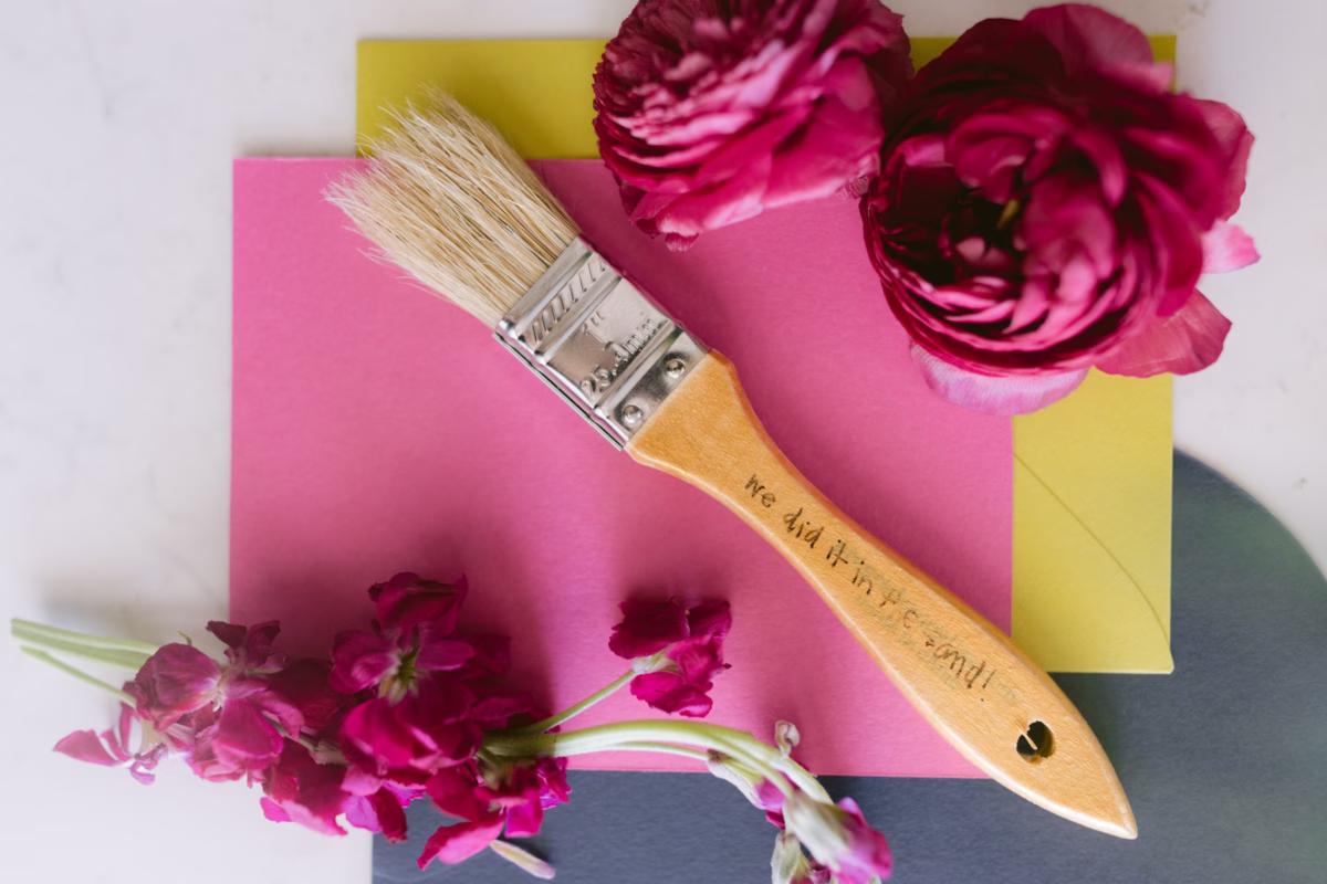 Wedding detail styling with pink ranunculus flowers and paintbrush by Arms of Persephone florist at Casa Marina Key West