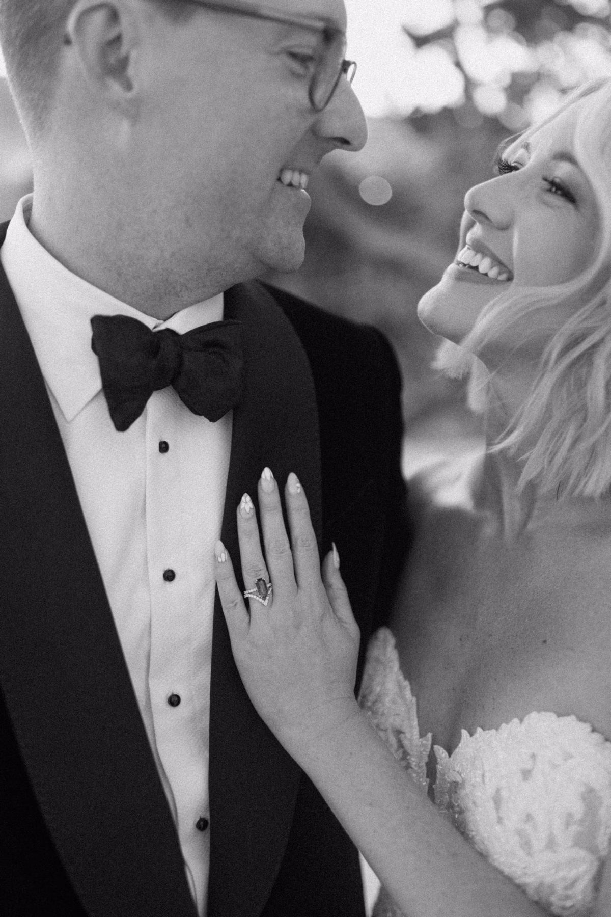 Black and white portrait of bride and groom laughing together at Casa Marina Key West wedding photographed by Ashley Izquierdo Photography