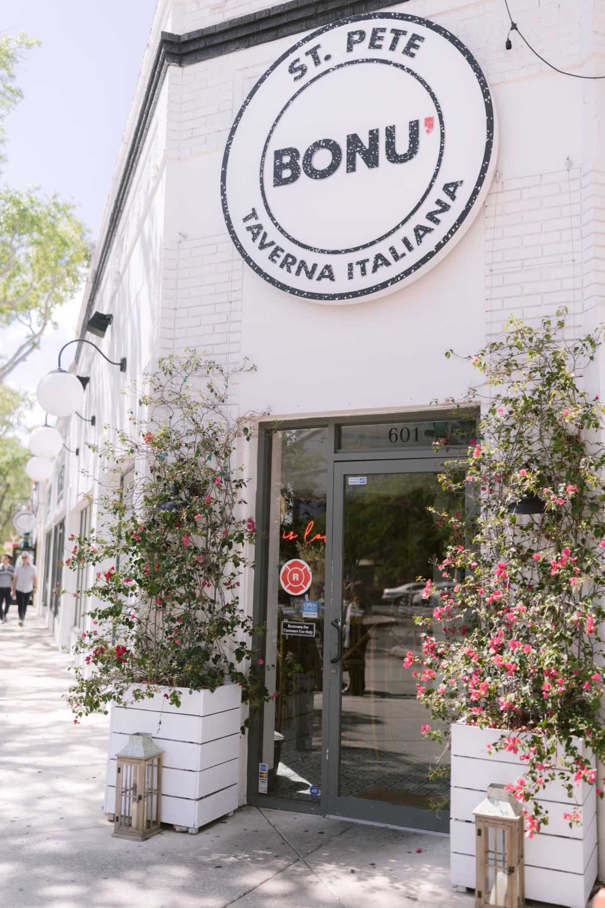 Bonu Taverna Italiana restaurant storefront in St Petersburg with flowering plants, a charming wedding reception venue option photographed by Ashley Izquierdo Photography