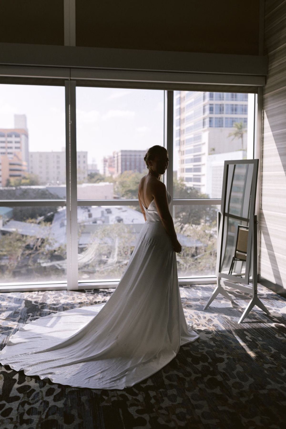 Bride in flowing wedding dress from Lovely Bride DC preparing for her St. Petersburg art museum wedding