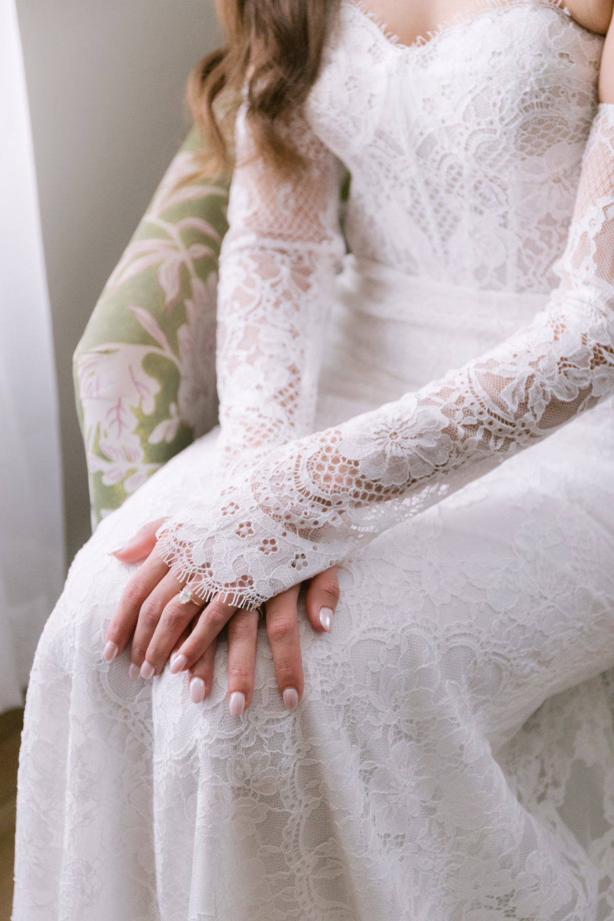 Elegant bridal portrait featuring intricate white lace wedding dress with long sleeves from Ella Blu Bridal at Soire Estate Tampa wedding photographed by Ashley Izquierdo Photography