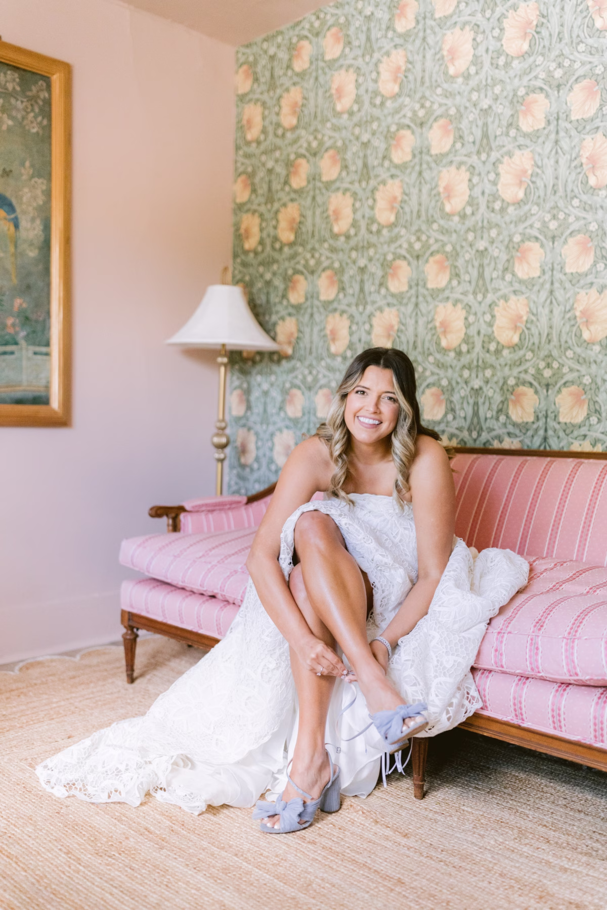 Bride in BHLDN wedding dress putting on shoes during getting ready at Hostess House in St. Petersburg