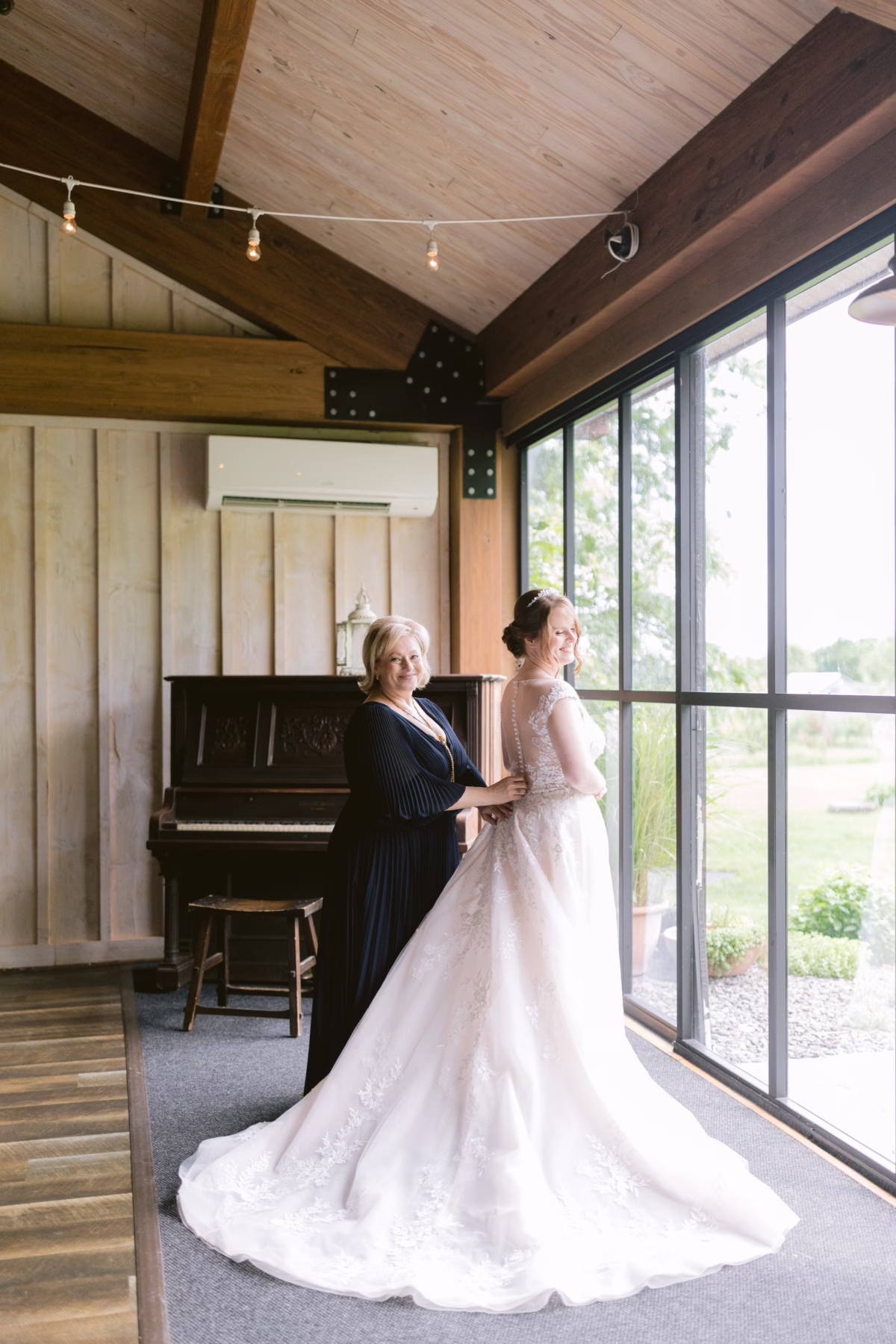 Bride in Maggie Sottero wedding dress getting ready with mother at Red Maple Vineyard photographed by Tampa Bay wedding photographer Ashley Izquierdo Photography