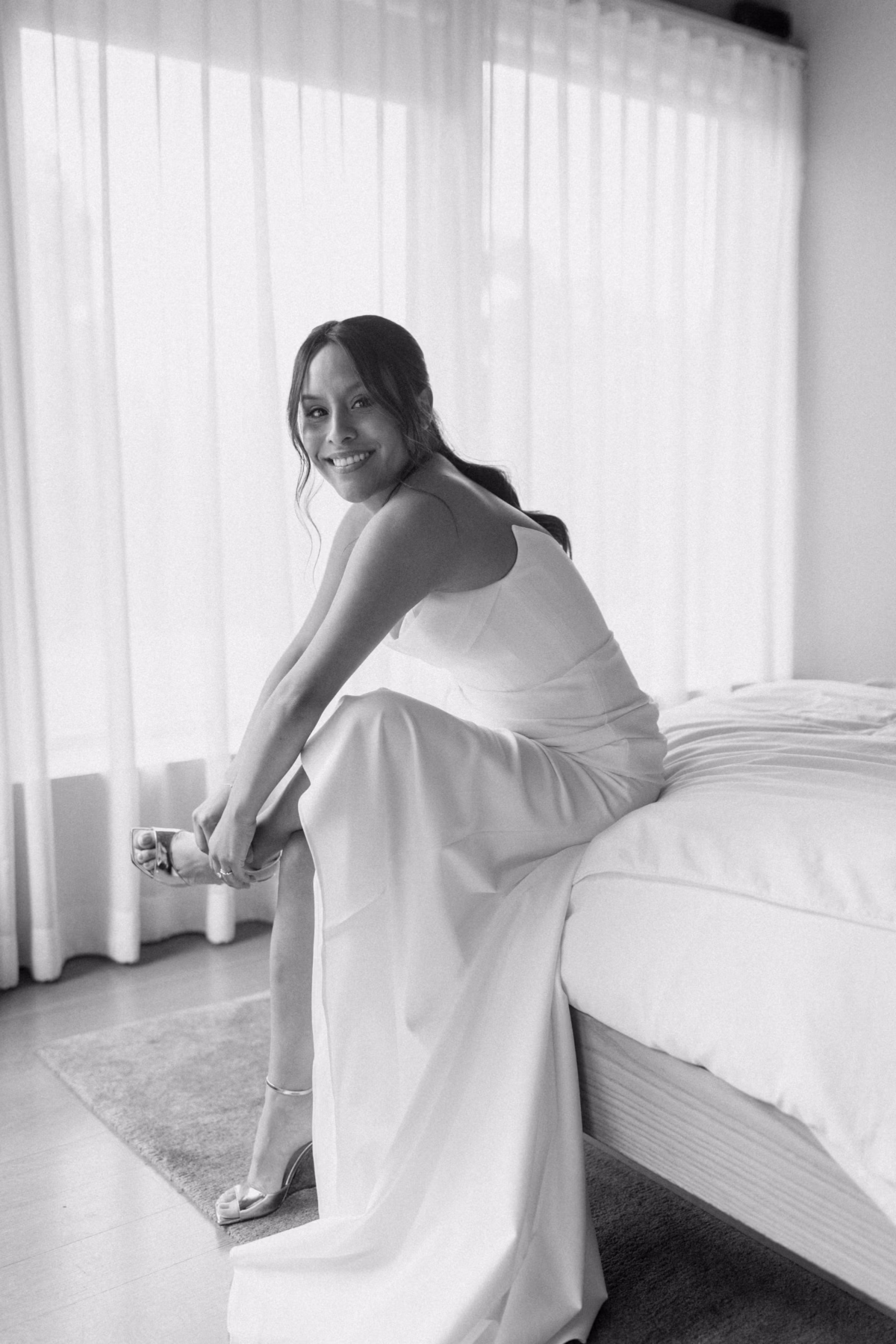 Bride in elegant white dress getting ready at The Roundhouse Beacon for her Hudson Valley wedding photographed by Ashley Izquierdo Photography