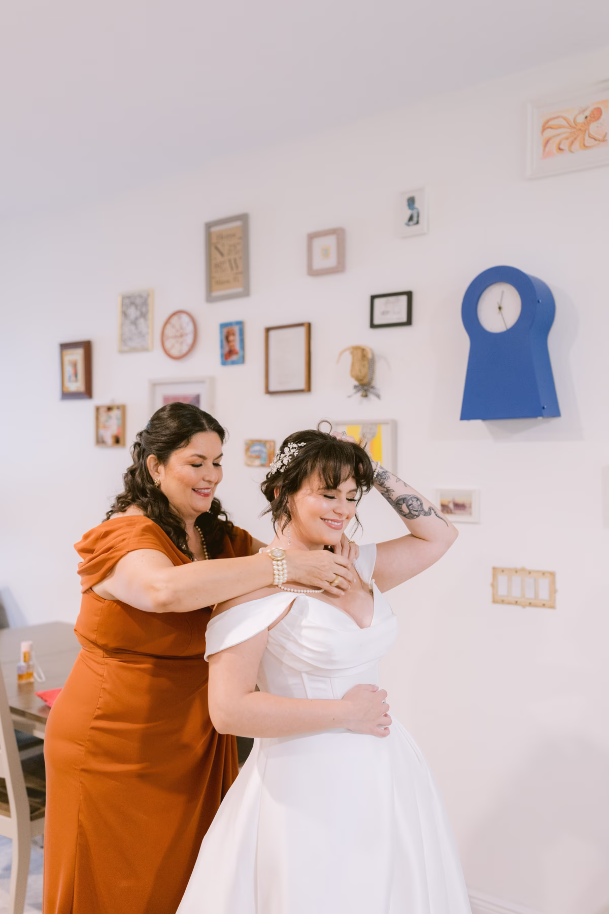 Bride getting assistance with her wedding dress from J Del Olmo Bridal Gallery during getting ready photos at Armature Works Tampa wedding
