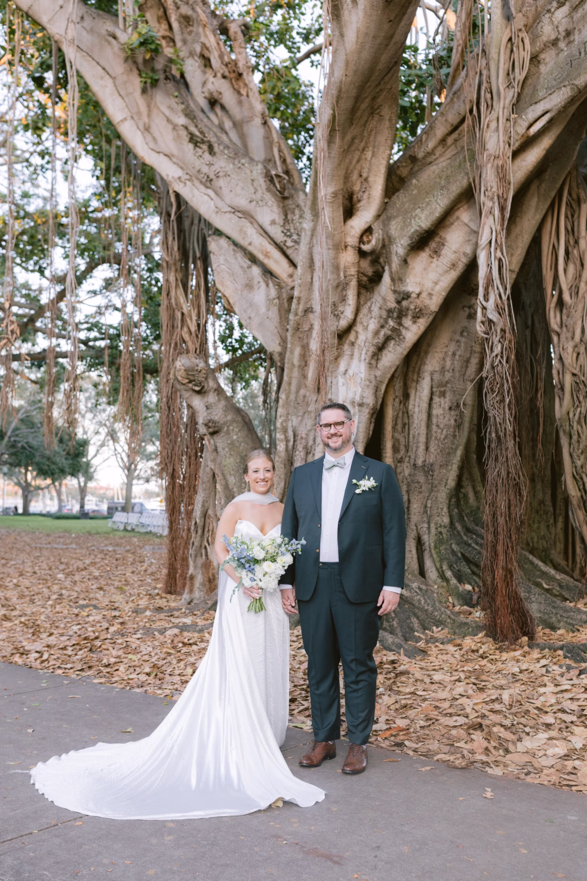 Bride and groom portraits under majestic banyan tree with Wonderland Floral Art bouquet at St. Petersburg art museum wedding photographed by Ashley Izquierdo Photography