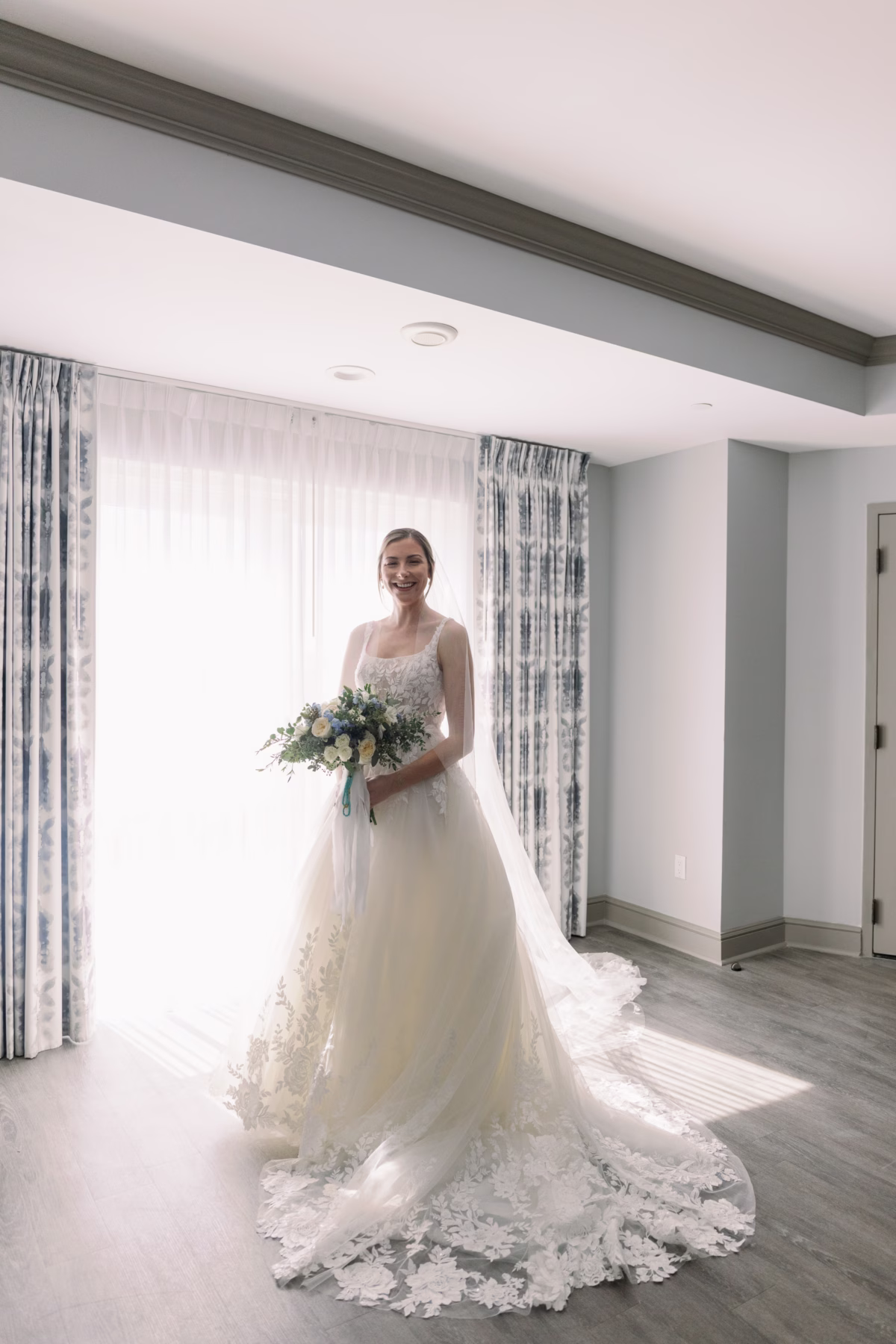 Bride in Justin Alexander wedding dress holding bouquet by Lemon Drops Weddings and Events at The Vinoy St Petersburg waterfront wedding