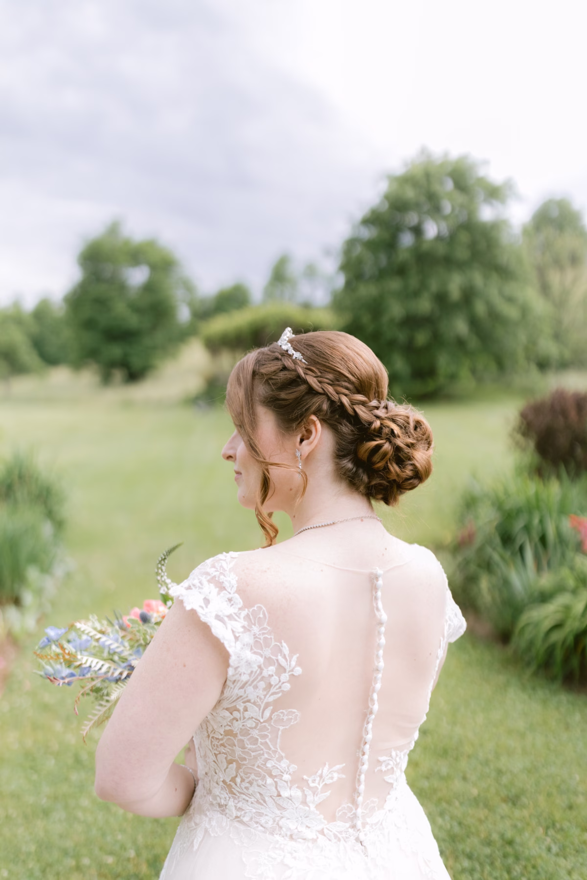 Bride in lace Maggie Sottero wedding dress with intricate updo by Pent Hair and Makeup at Red Maple Vineyard photographed by Ashley Izquierdo Photography