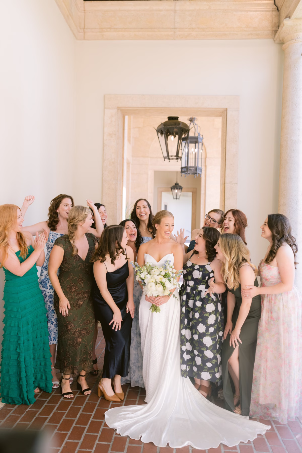 Bride holding Wonderland Floral Art bouquet surrounded by friends at Nancy Cotto Events venue in St. Petersburg captured by Ashley Izquierdo Photography