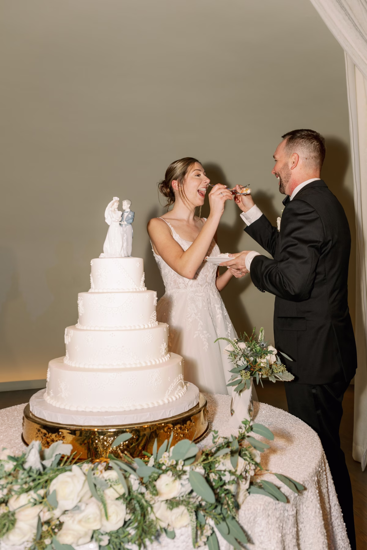 Bride and groom cutting elegant white tiered wedding cake by Cakes by Carolynn at The Vinoy St Petersburg waterfront wedding