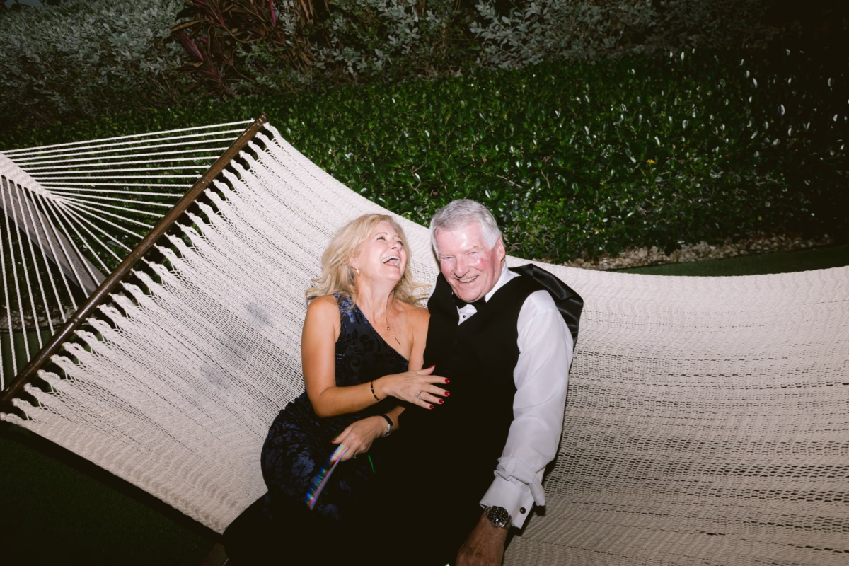 Wedding couple laughing together on hammock at Casa Marina Key West captured by Ashley Izquierdo Photography