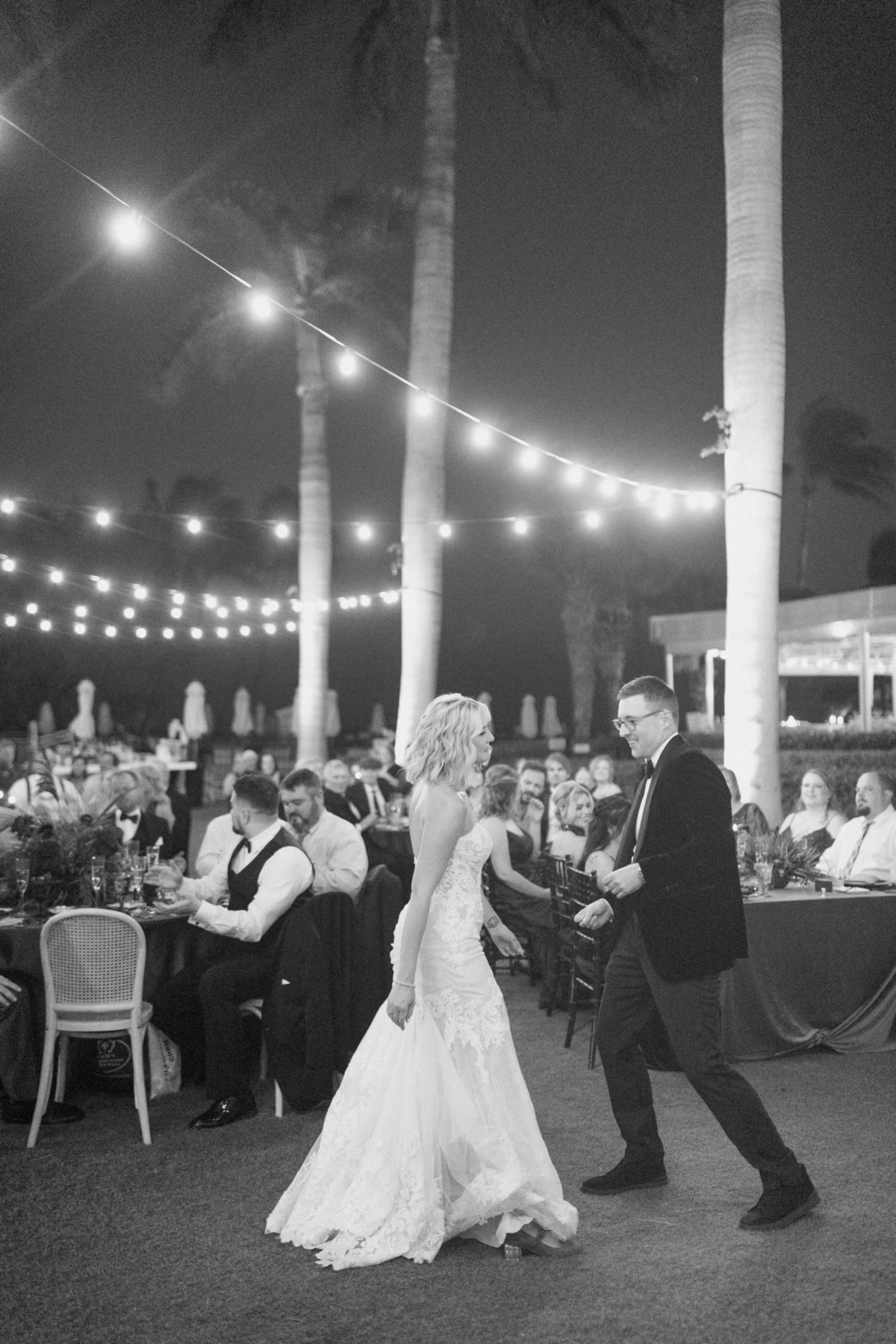 Bride and groom sharing their first dance under string lights at Casa Marina Key West wedding reception photographed by Ashley Izquierdo Photography
