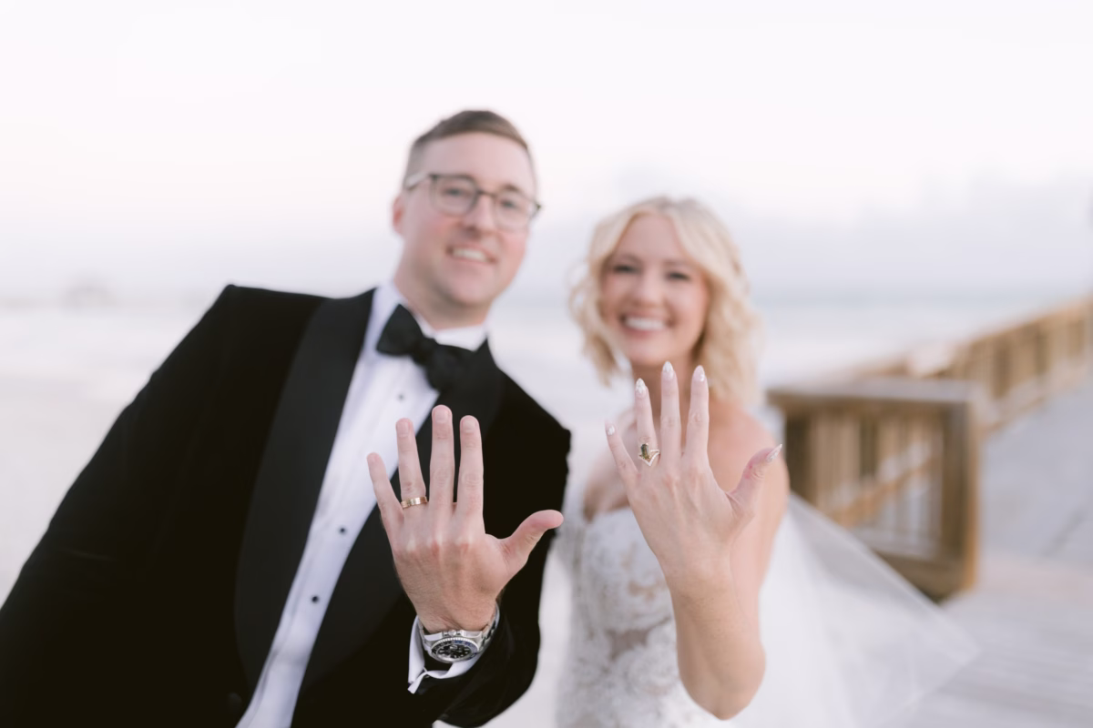 Newlywed couple shows off wedding rings at Casa Marina Key West wedding photographed by Ashley Izquierdo Photography