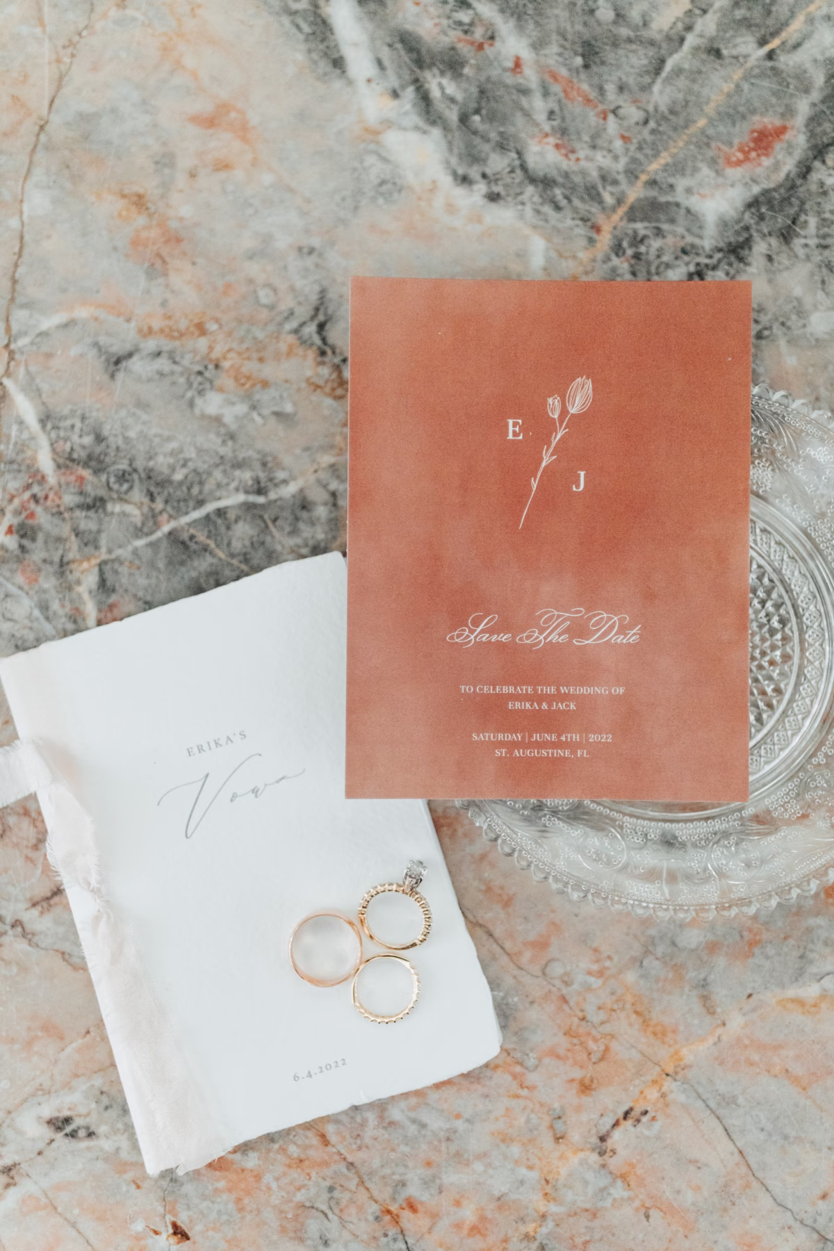 Coral save the date invitation by Zola with wedding rings on marble surface for Lightner Museum wedding in St Augustine