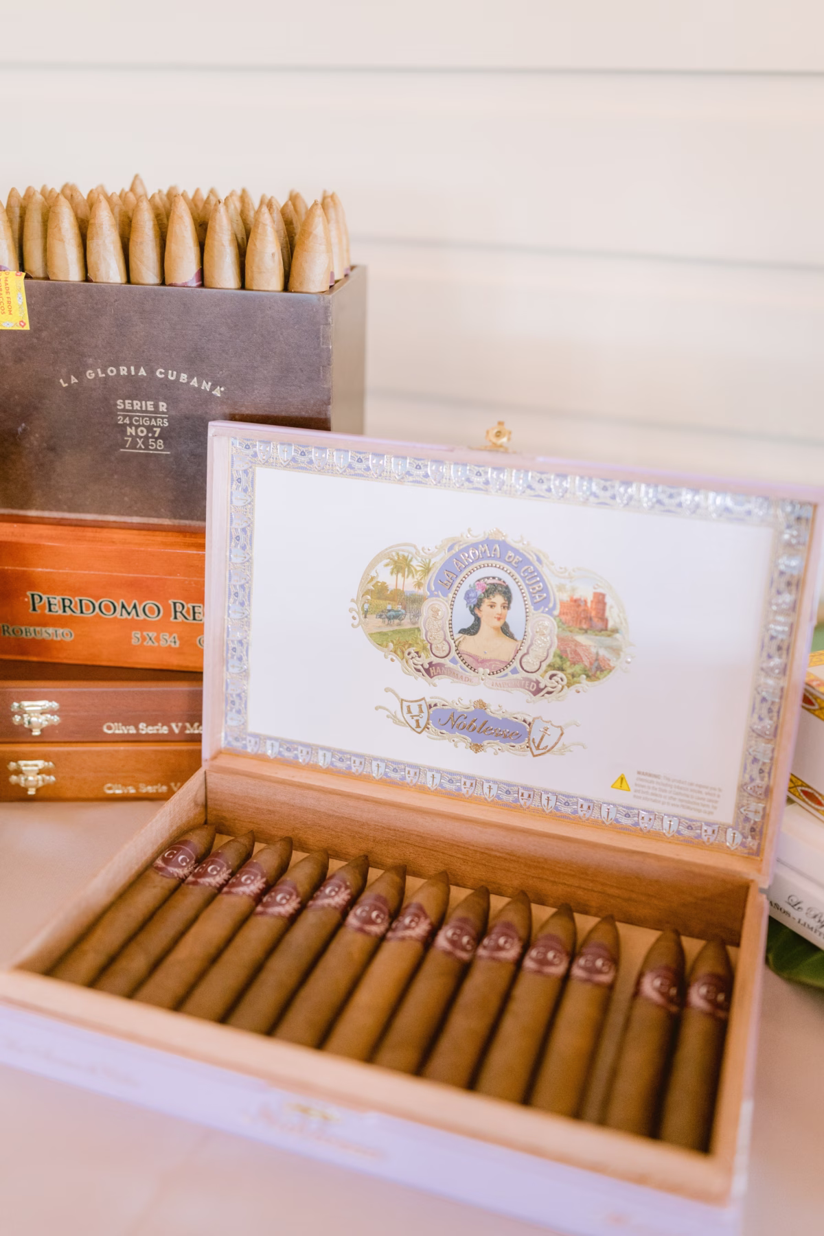 Elegant Cuban cigars displayed in wooden boxes for wedding reception at Armature Works Tampa photographed by Ashley Izquierdo Photography