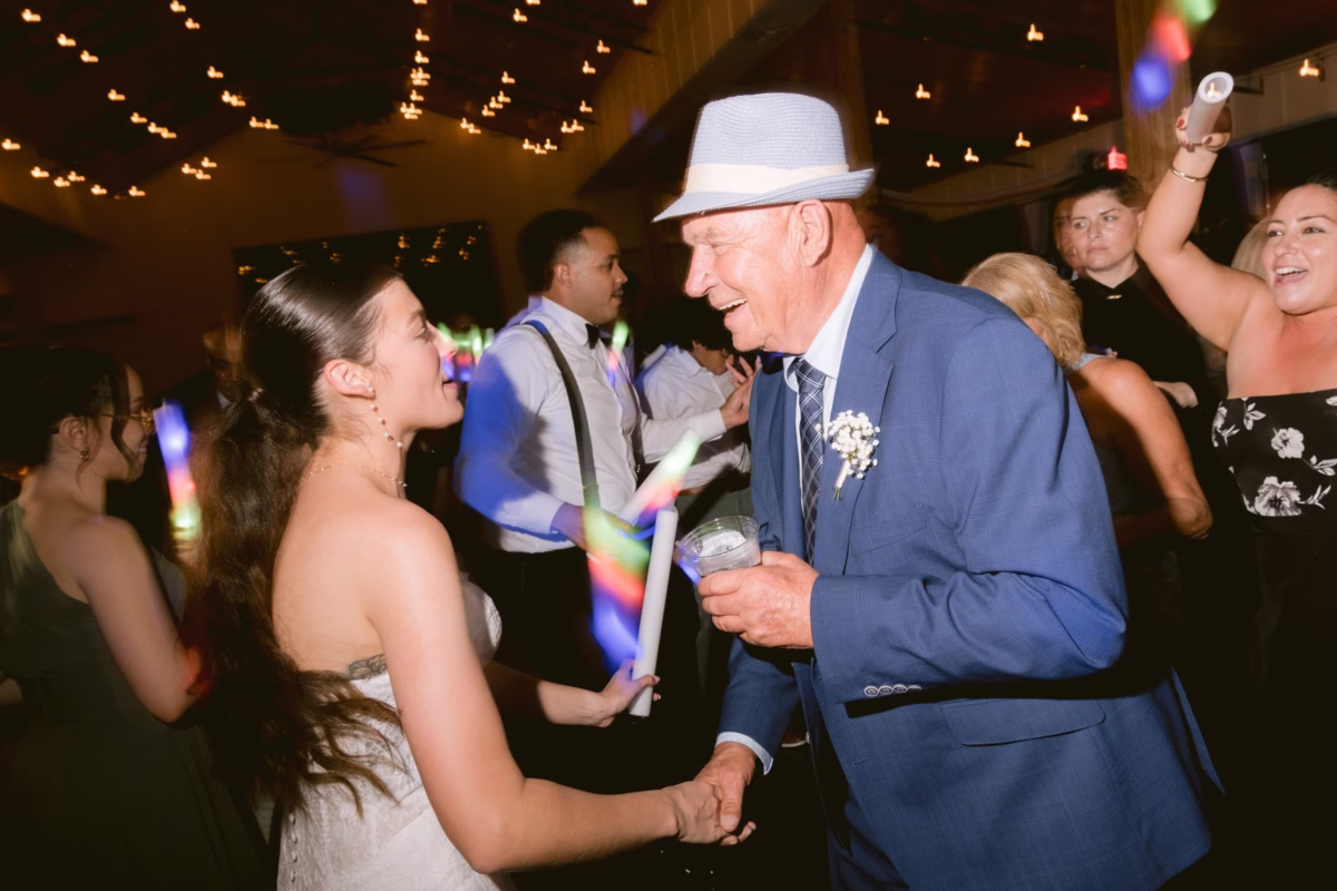 Bride and groom dancing together during their wedding reception at Soire Estate in Tampa with string lights overhead