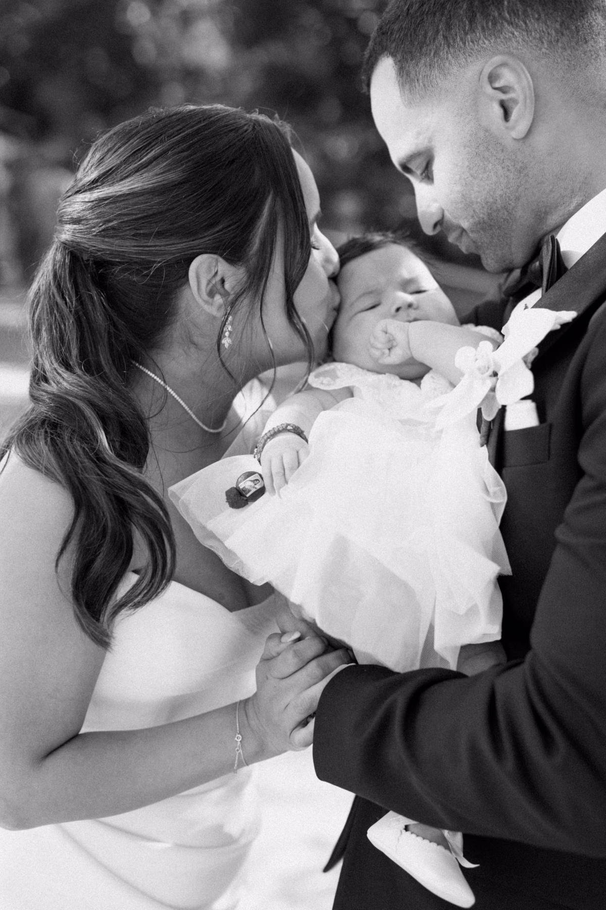 Intimate family portrait of couple with baby at The Roundhouse Beacon Hudson Valley wedding photographed by Ashley Izquierdo Photography