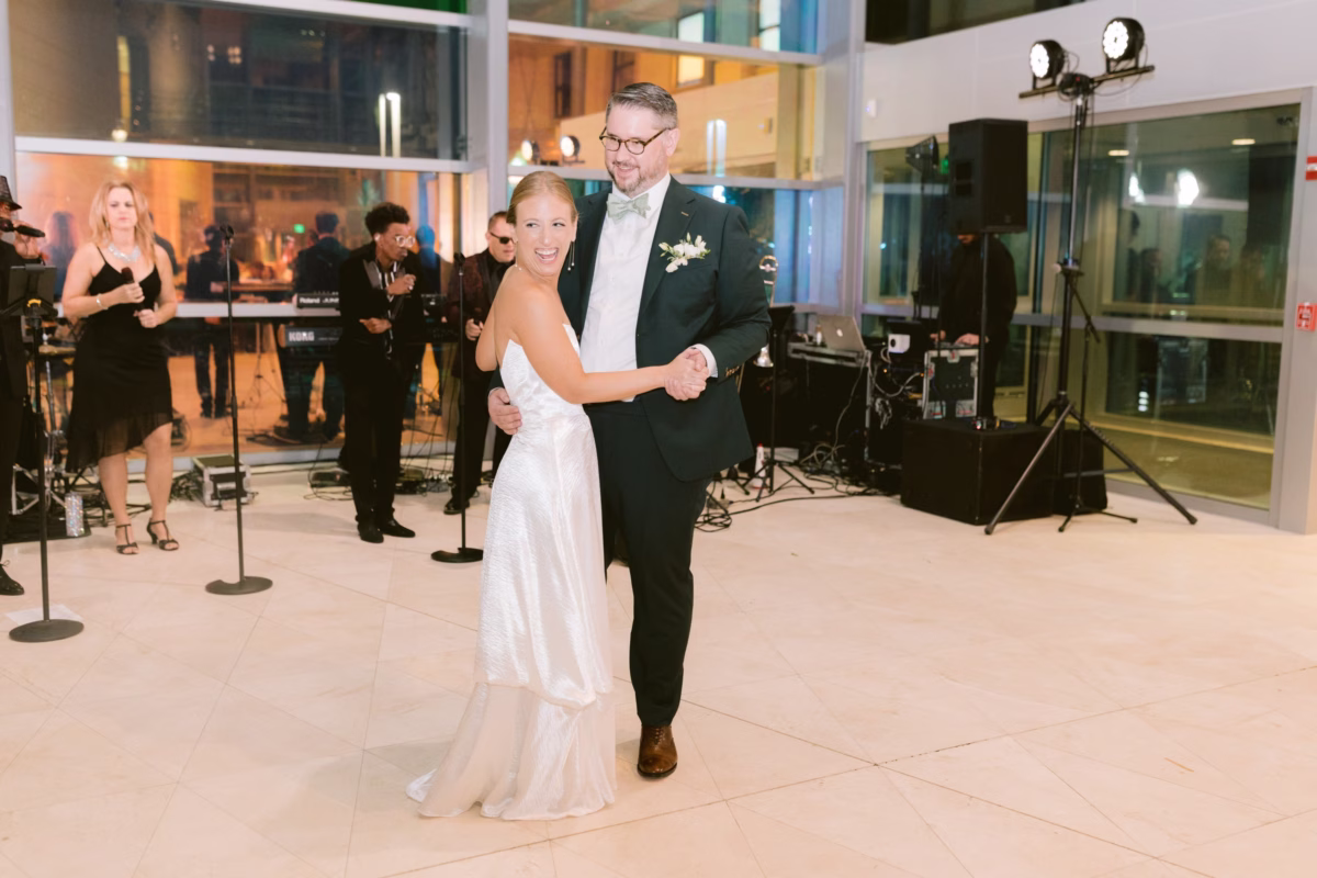 Bride and groom share their first dance with Finesse Party Band performing at this elegant art museum wedding in St. Petersburg captured by Ashley Izquierdo Photography