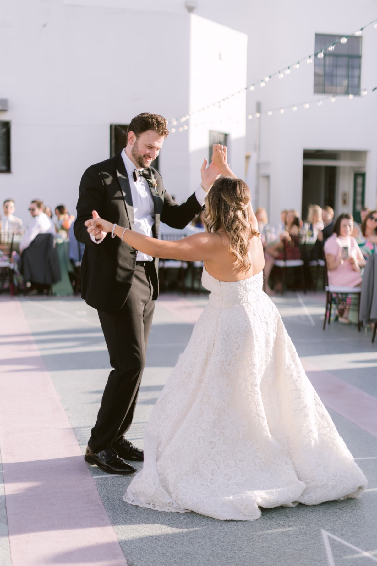 Bride and groom share their first dance at St. Pete Shuffleboard Club with wedding coordination by Day of Details