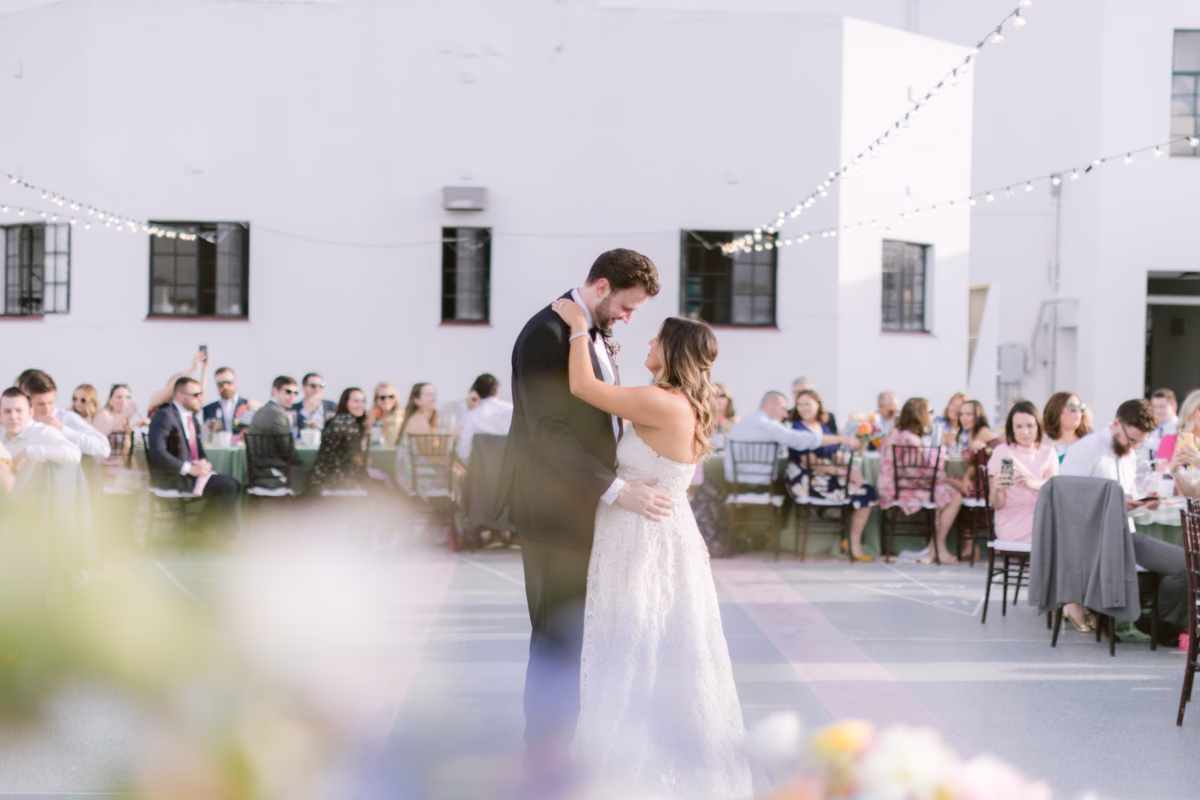 Bride and groom share their first dance at St. Pete Shuffleboard Club with wedding planning by Day of Details