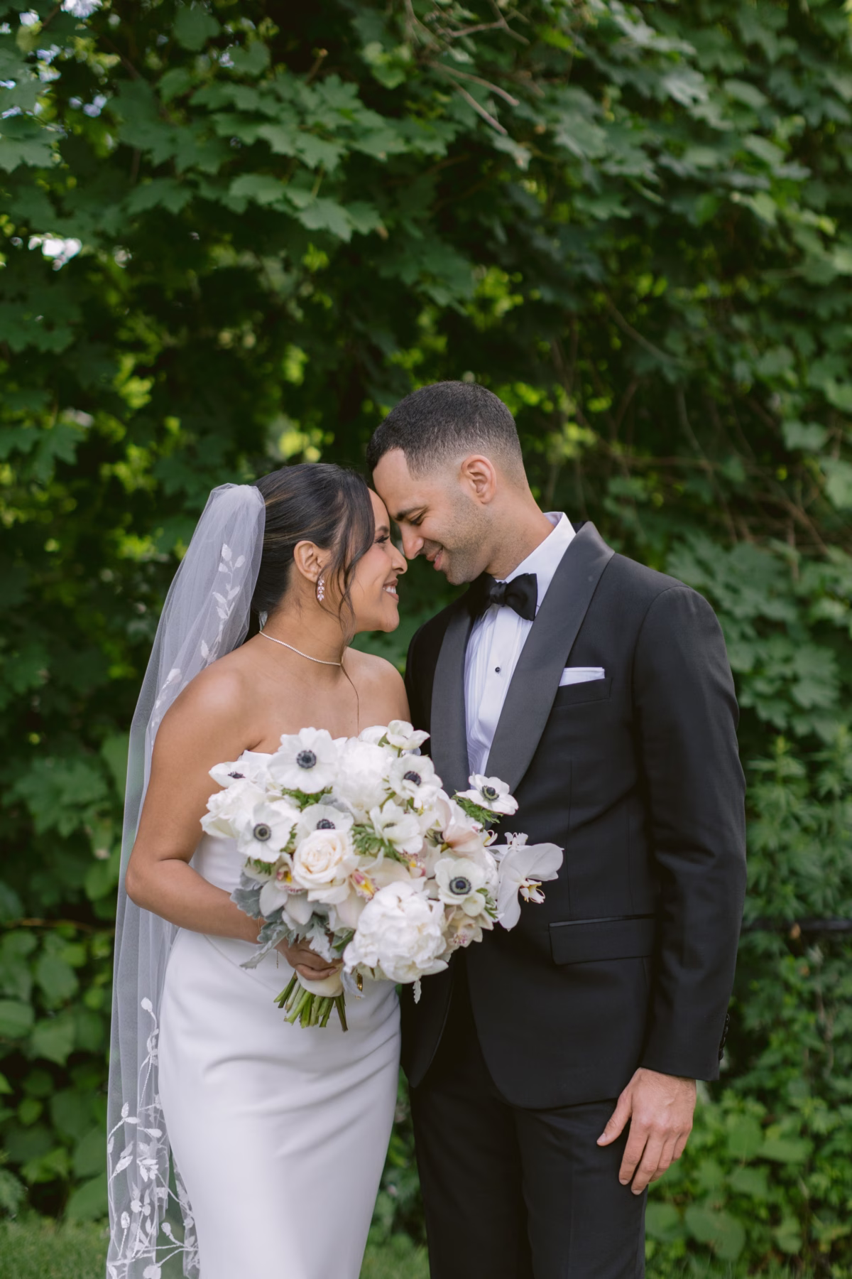 Bride and groom share intimate moment with white floral bouquet by Maky The Diva Flowers at The Roundhouse Beacon Hudson Valley wedding