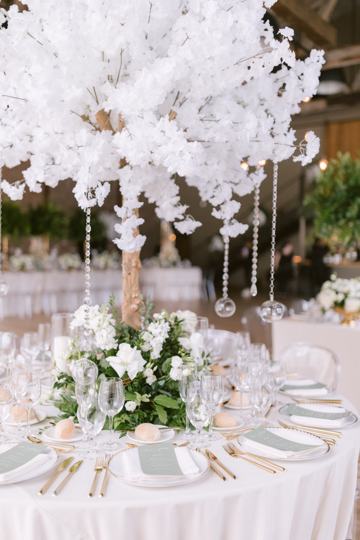 Elegant white floral centerpiece with hanging crystals by Maky The Diva Flowers at The Roundhouse Beacon wedding reception